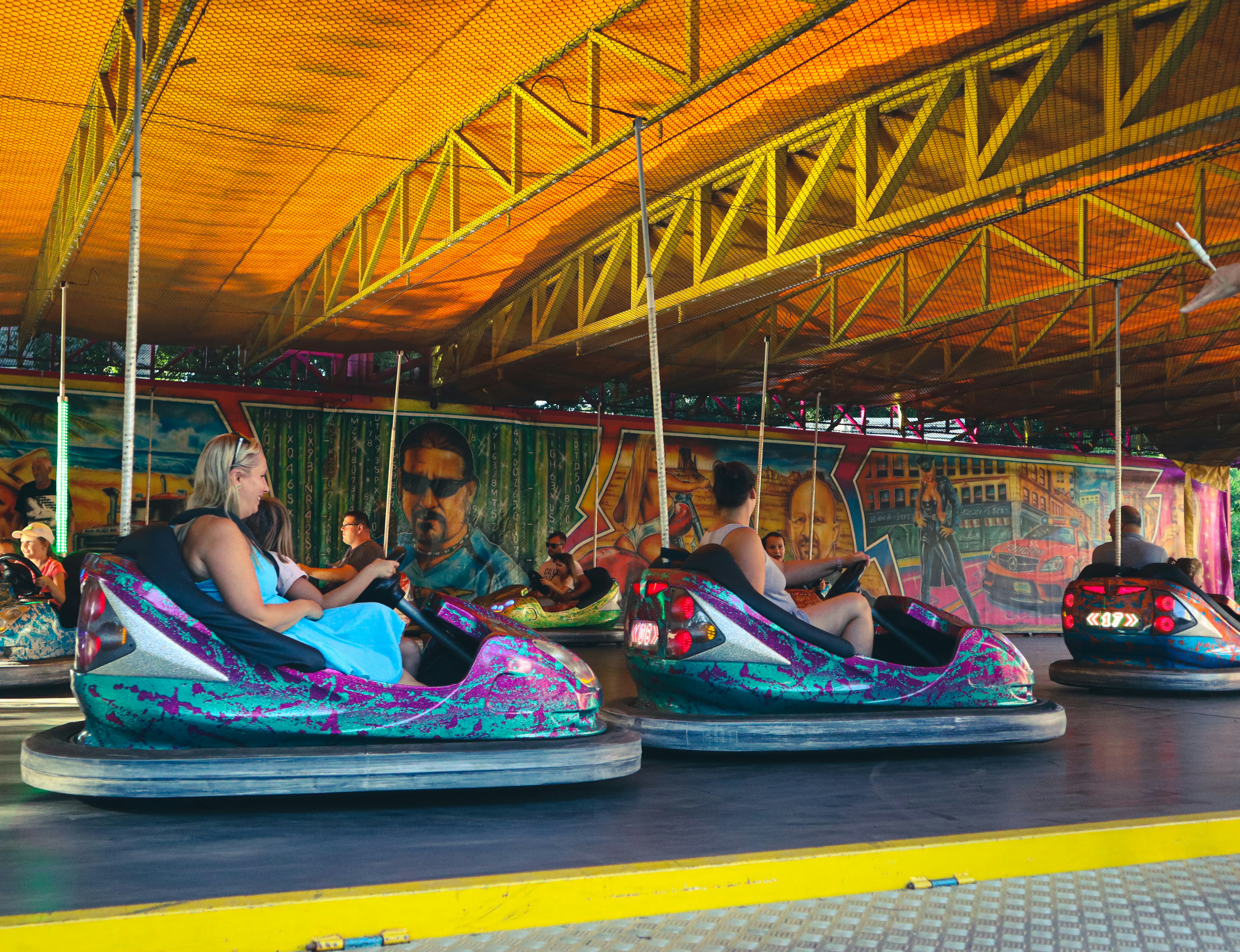 a group of people riding bumper cars in a carnival
