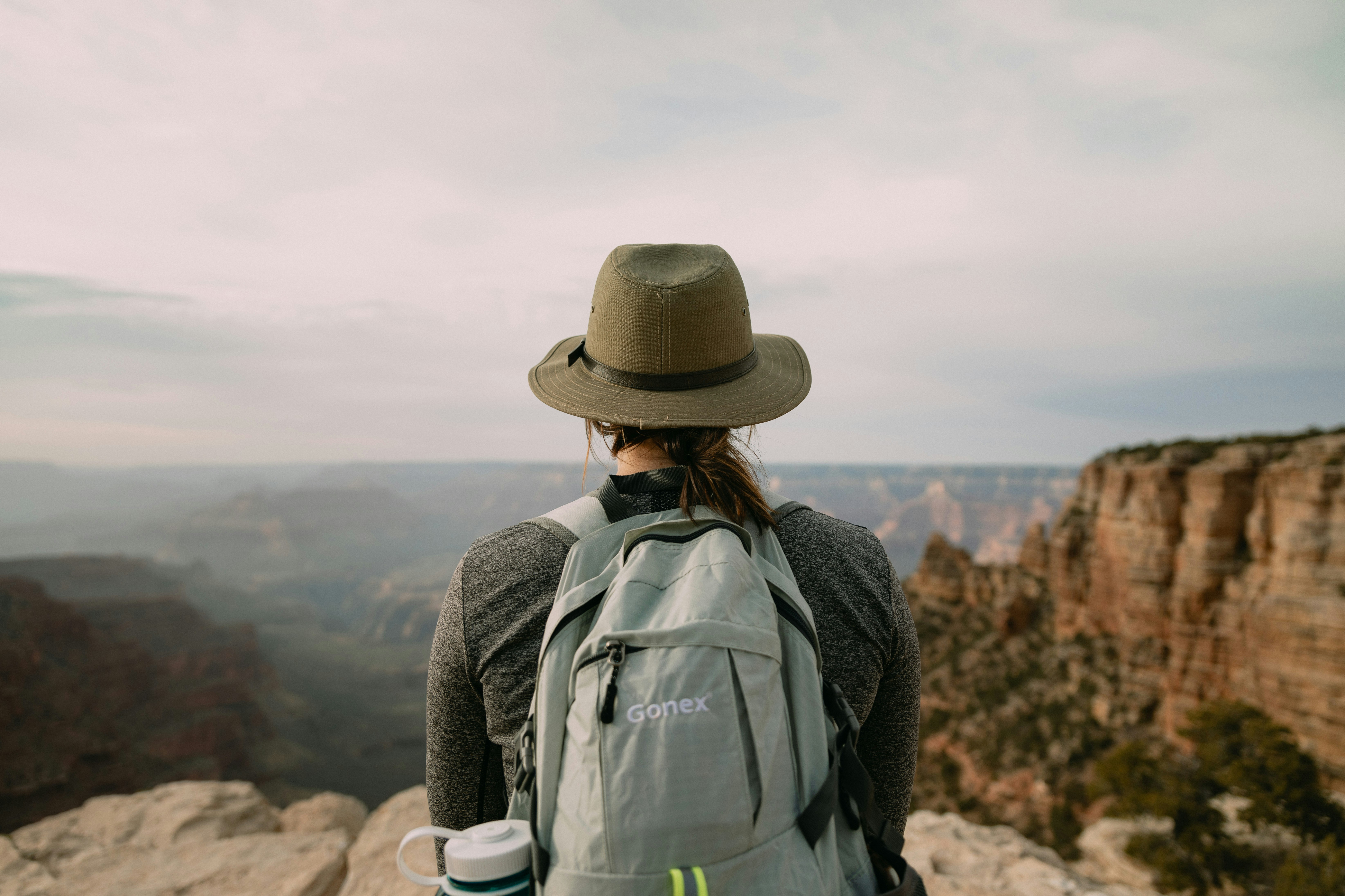 person looking on rock mountain during daytime