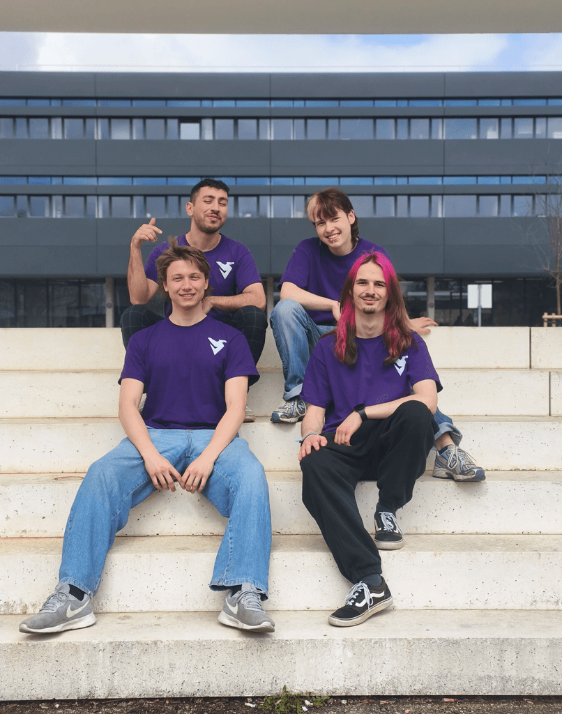 DDI team relaxing together on stone steps outside