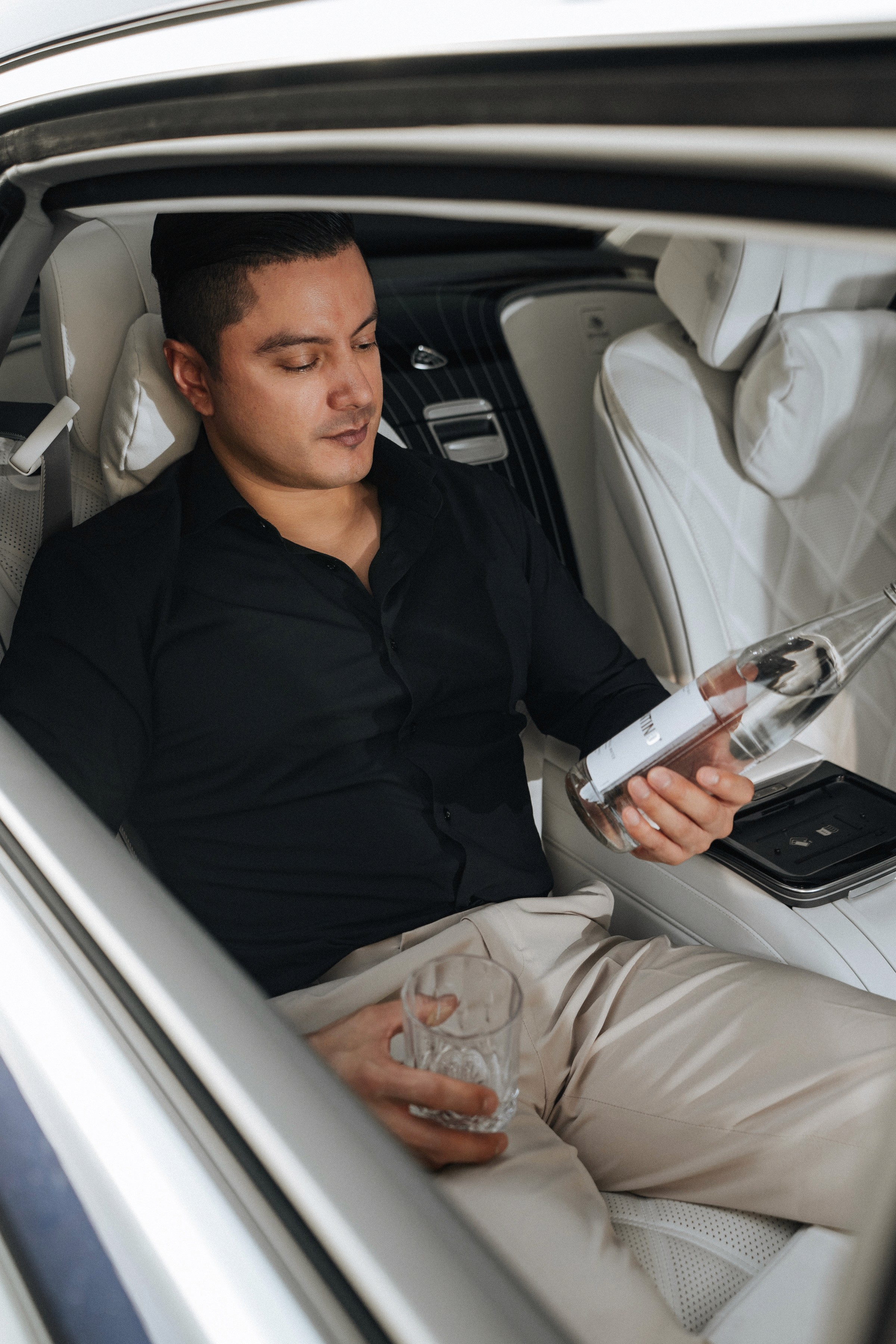 A man studying the mineral contents list of his bottle of mineral water.