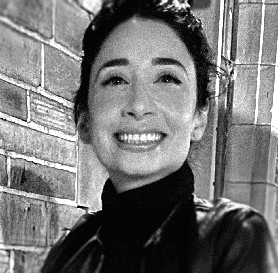 Profile portrait of a man in a white shirt against a light background