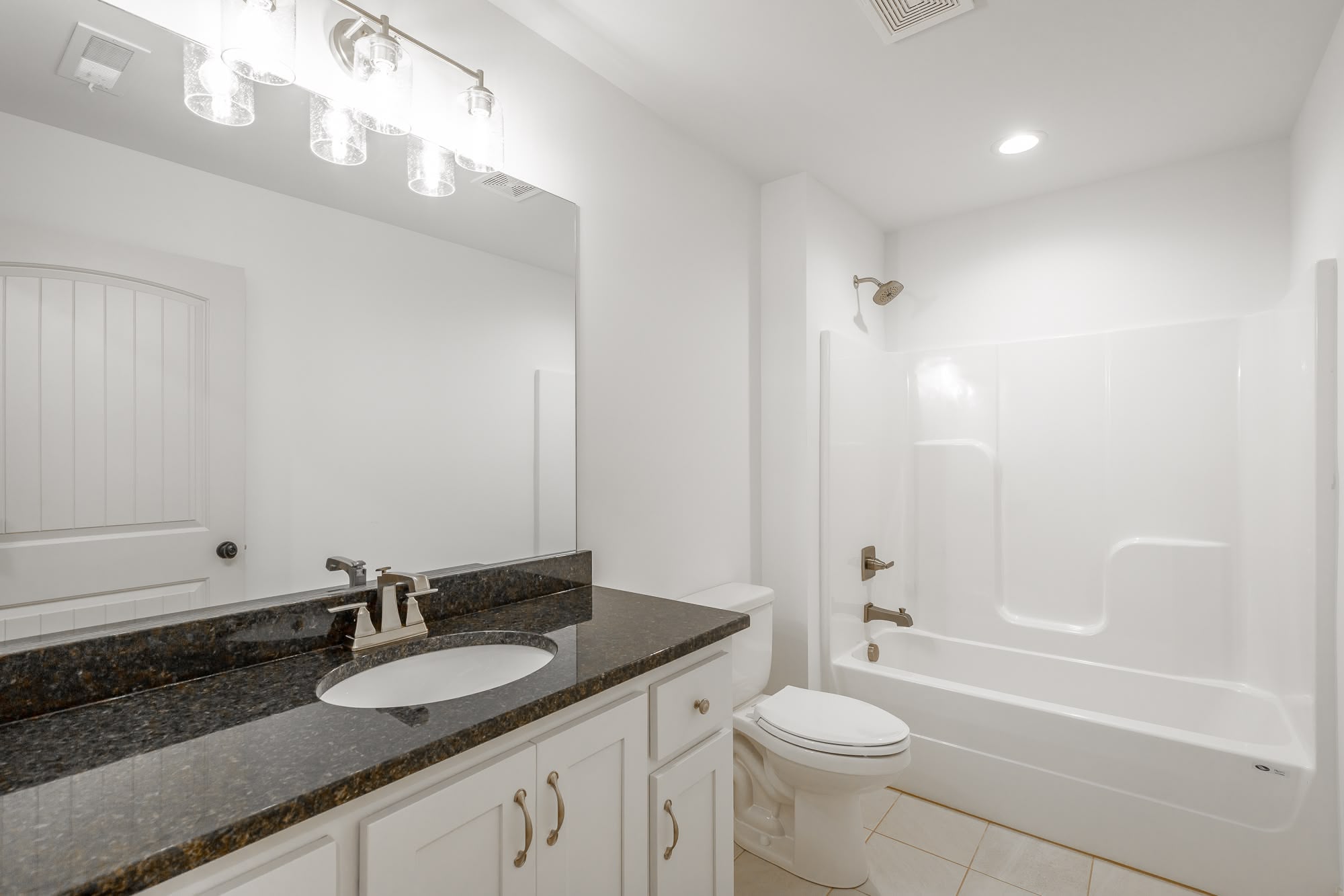 Large living room with custom fireplace and hardwood floors