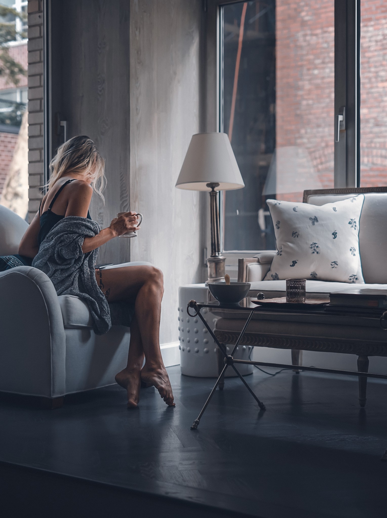 A woman relaxed at home on her sofa.