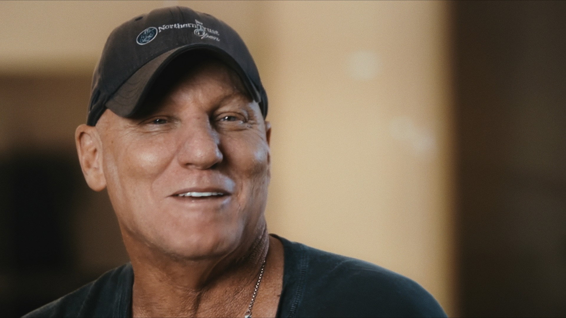 A man in a cap smiling, close up, Maddman