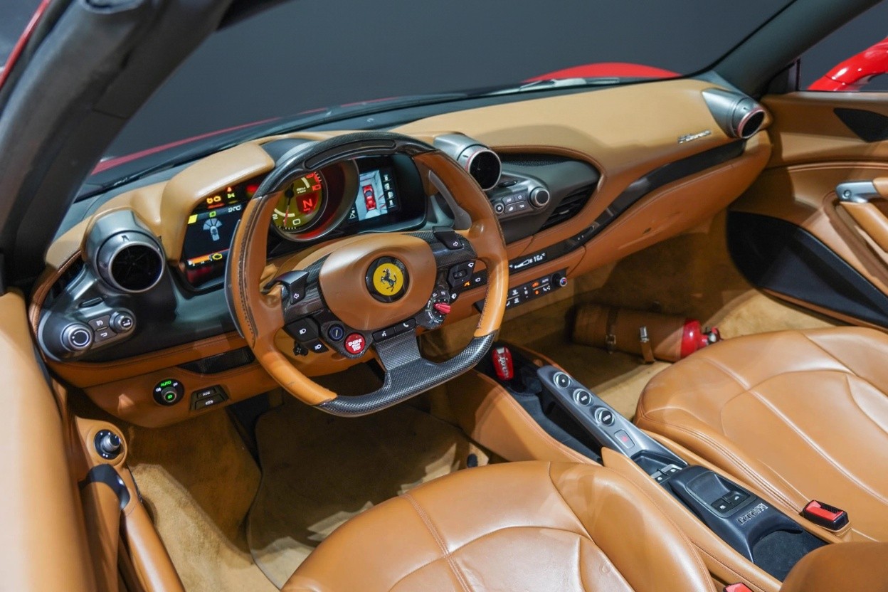 Ferrari F8 Spider 2023 interior cockpit with carbon fiber and premium leather, luxury car rental Dubai