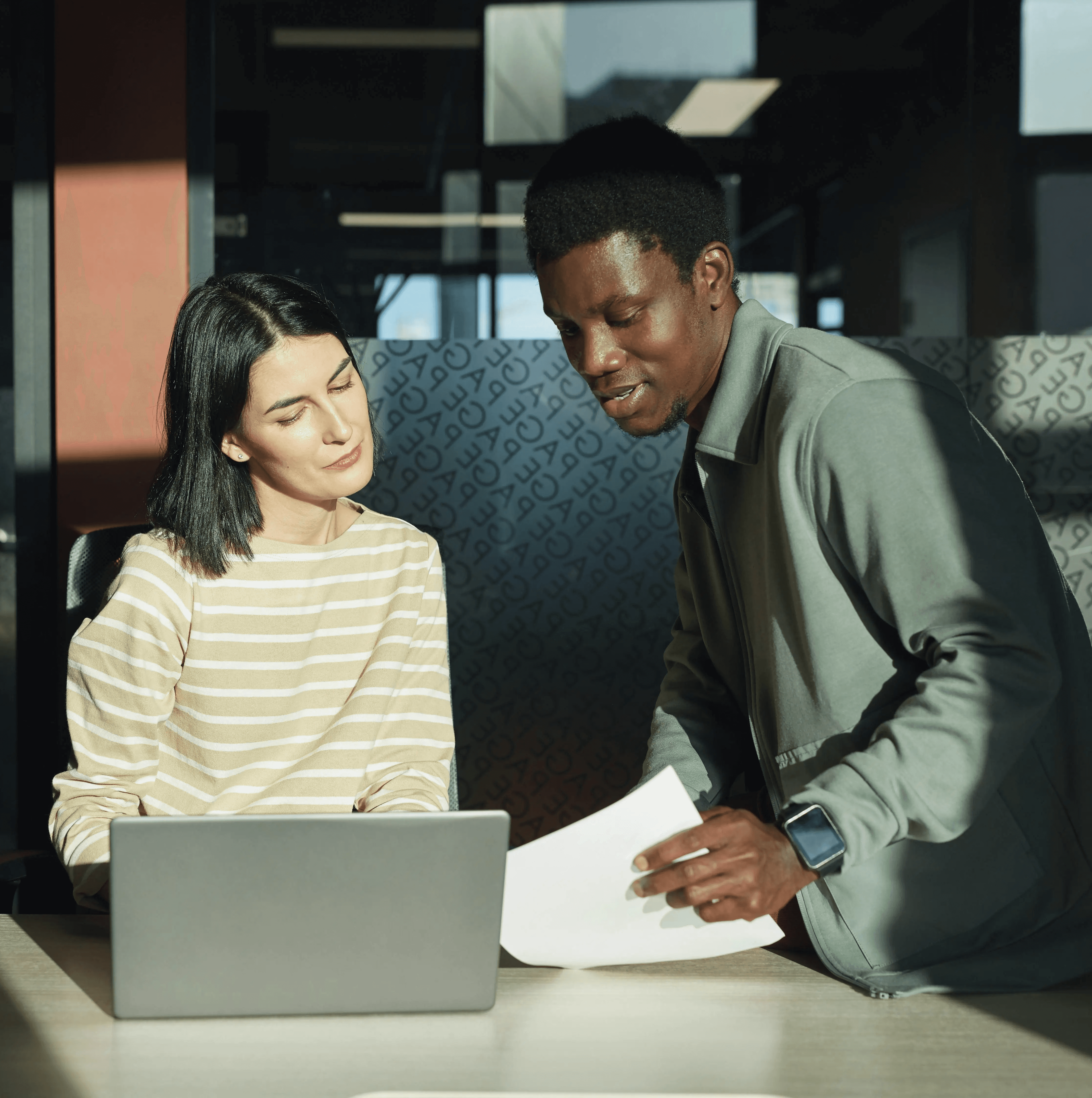 Two expat professionals collaborating in an office, building network connections in Germany