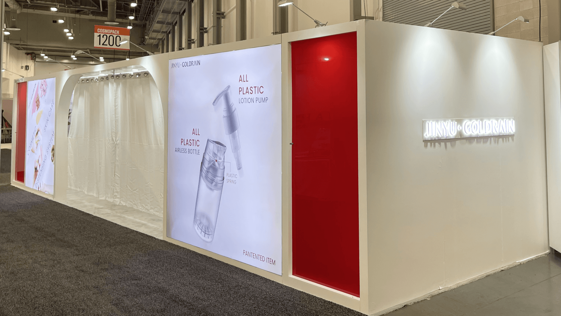 Lightbox panel and branded wall zone highlighting airless bottle and lotion pump packaging in Goldrain booth
