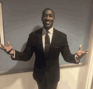 Handsome man in a suit looking at the camera and posing