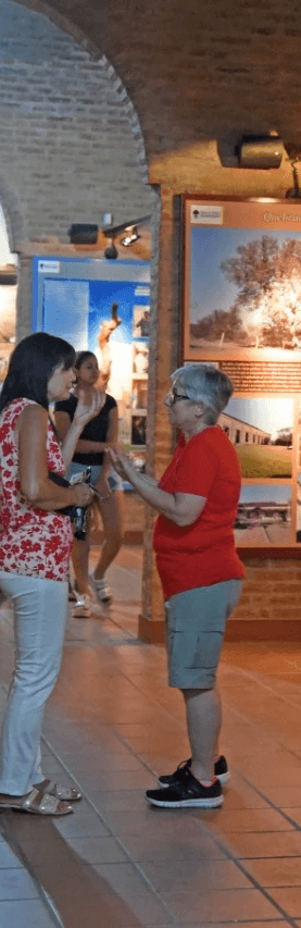 Portrait of a person in a pink sweater against a light background
