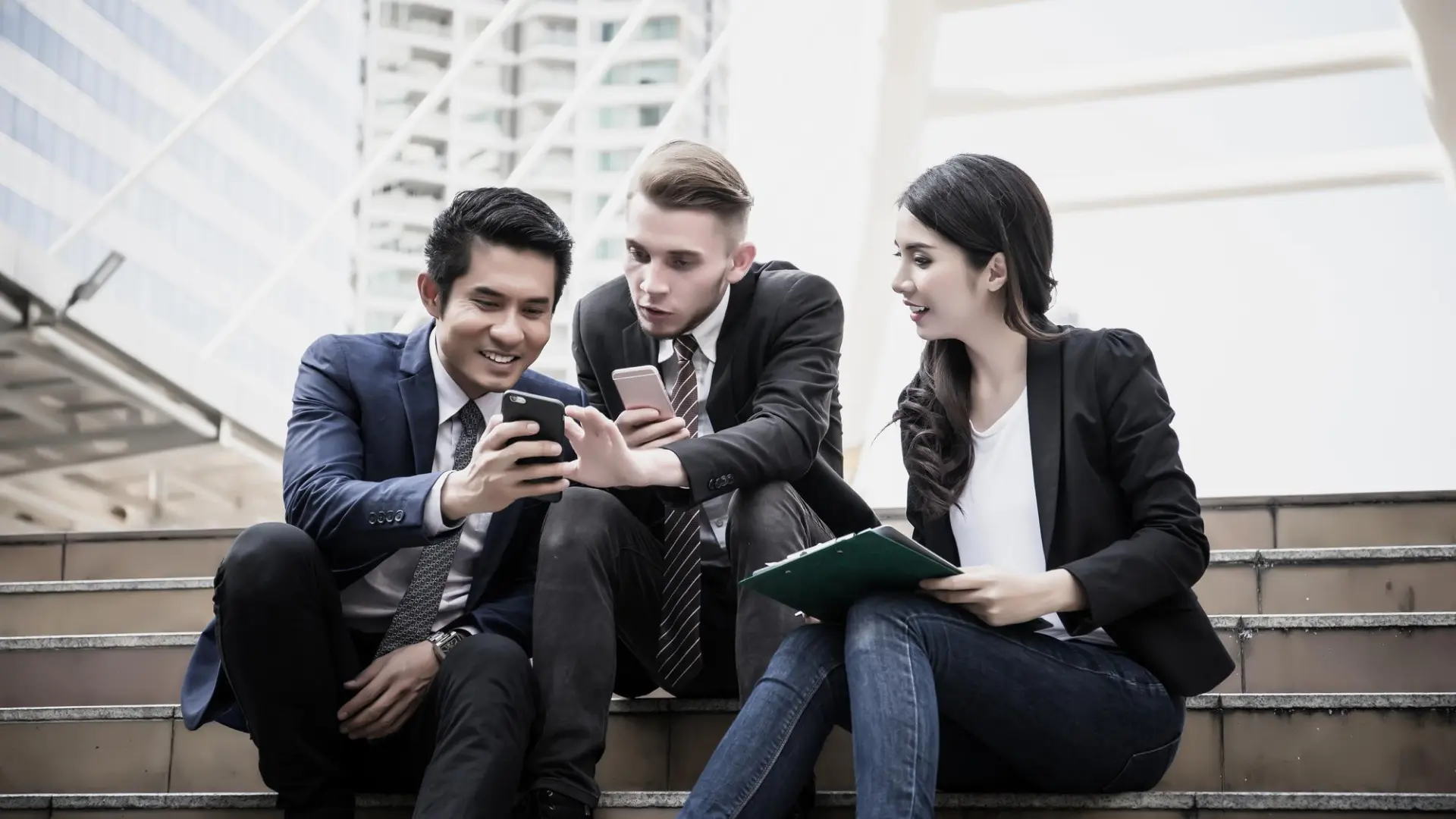 A group of young professionals discusses #careertok videos and job search strategies on a smartphone.