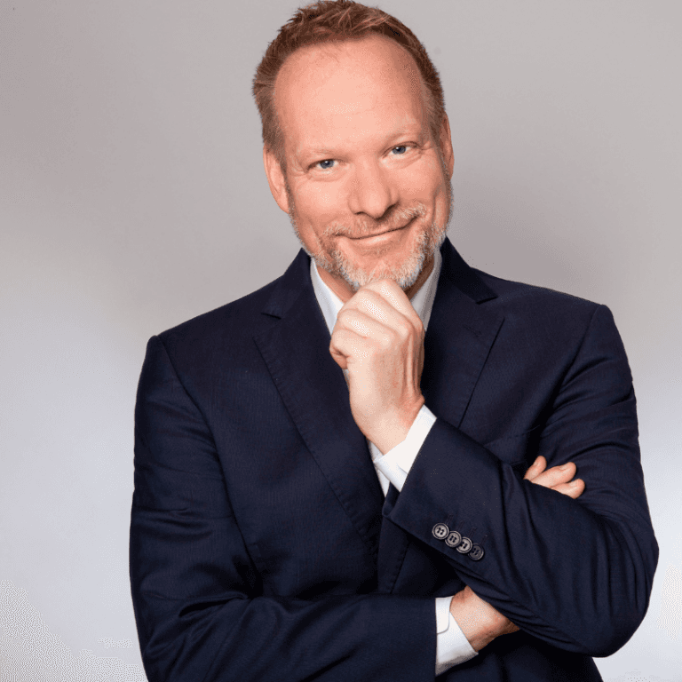 older man glaring into the sunset and rays of sunlight shine on his face