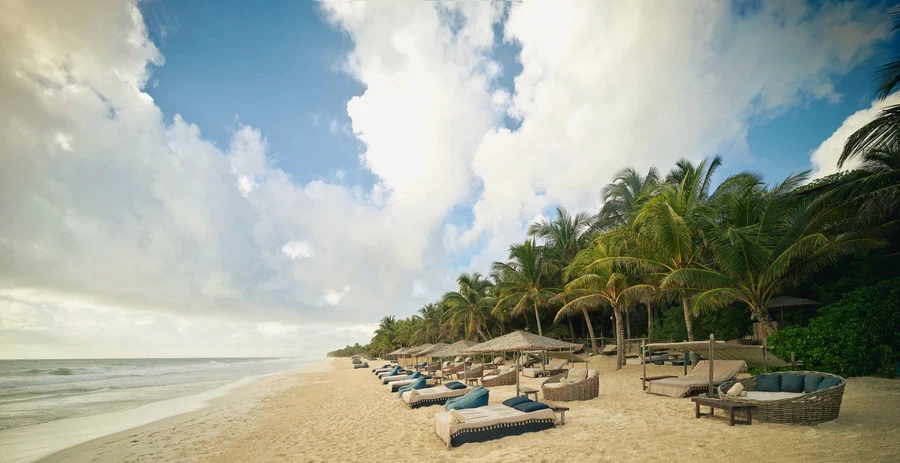 Pool area surrounded by jungle ambiance with loungers and tranquility at Be Tulum.