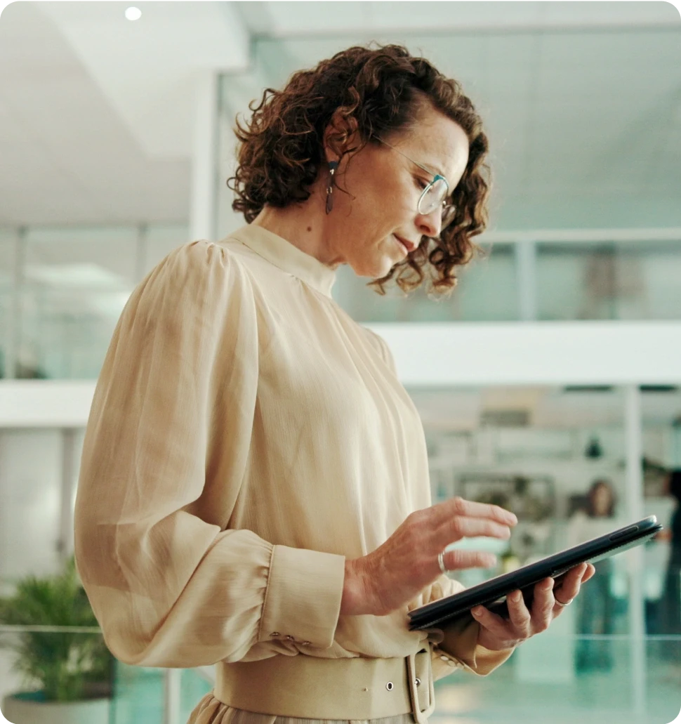 A dark cylindrical object on a wooden bar, with softly glowing lights in the blurred background.