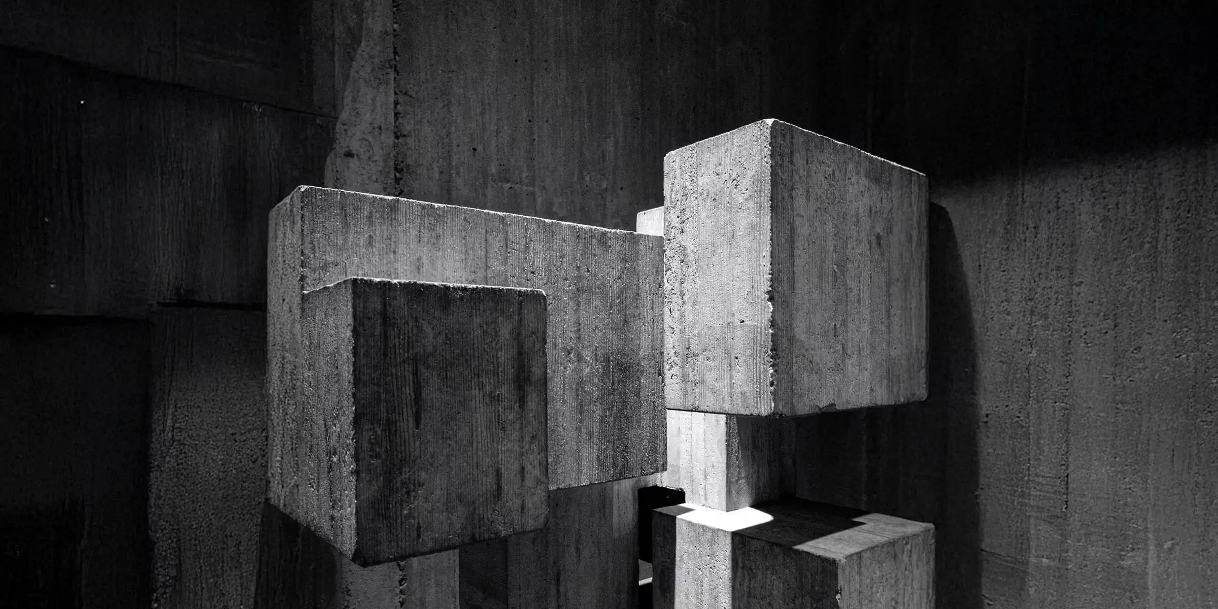 Abstract concrete blocks stacked together, symbolising strong structural foundations and long-term stability.