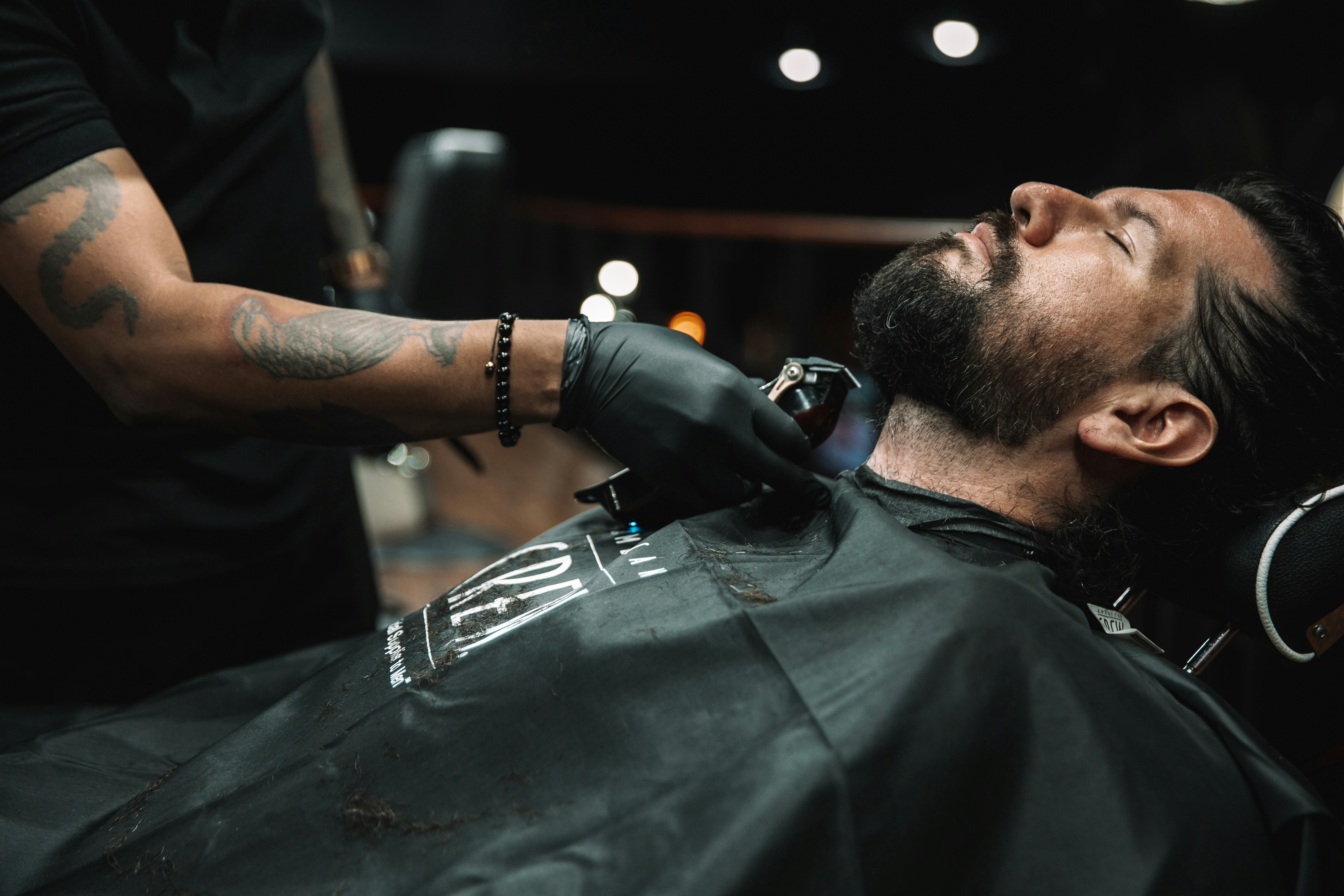 a man getting his hair cut at a barber shop