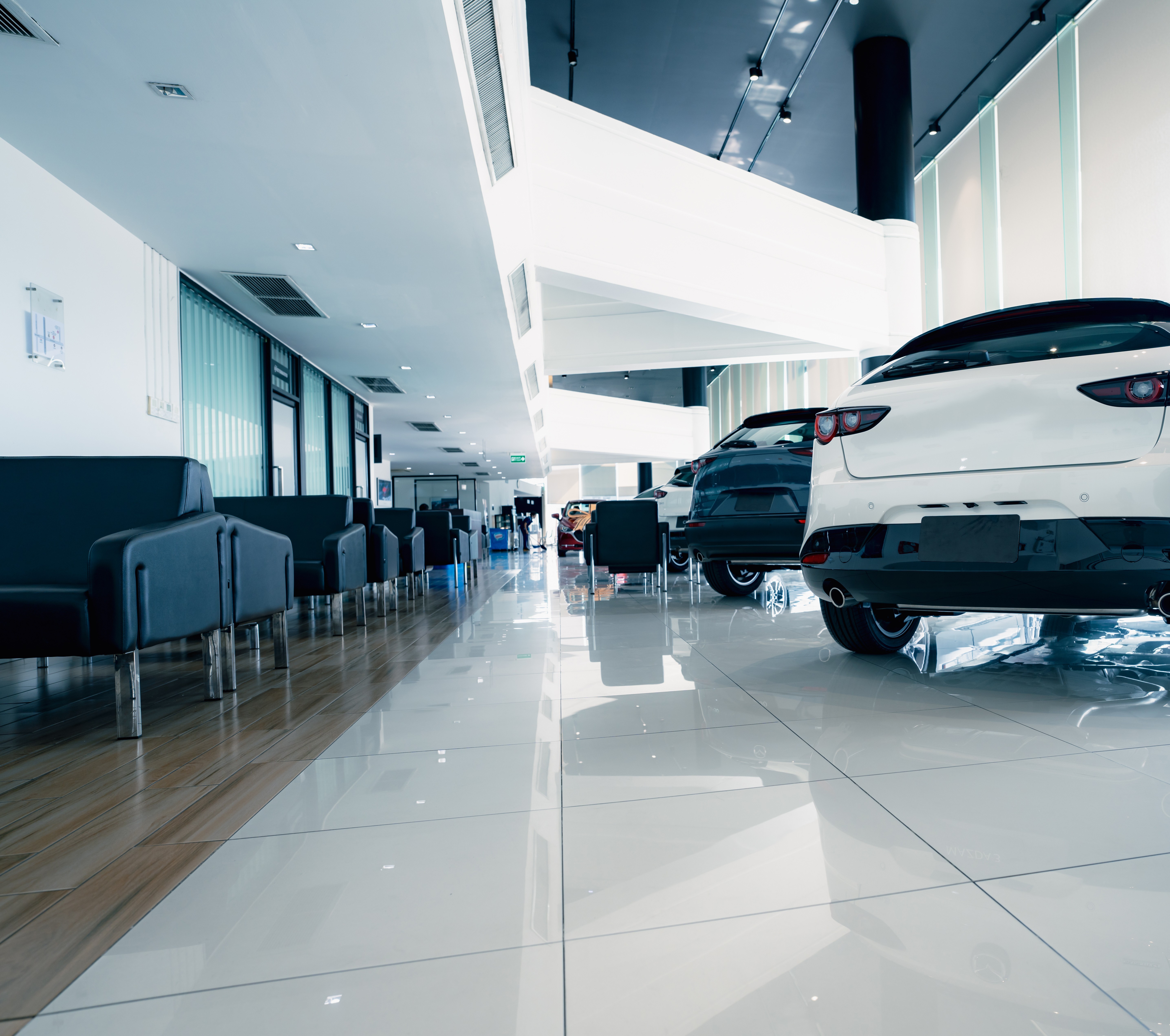 Greenhous automotive showroom fit-out with display vehicles, waiting area and polished dealership flooring