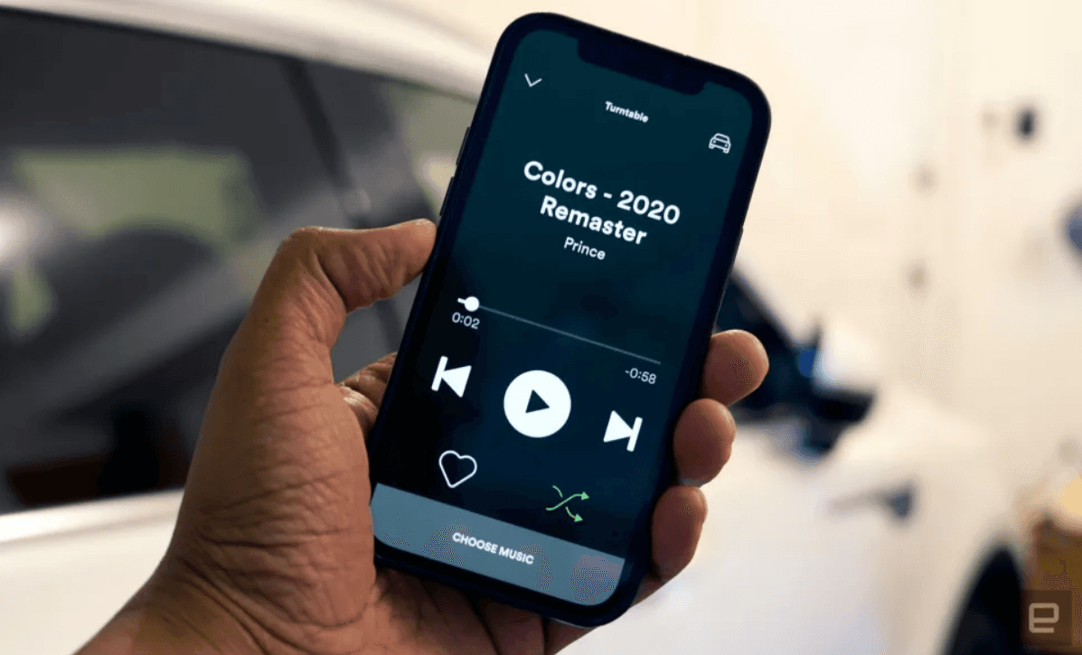 Person holding phone with Spotify Car mode on screen