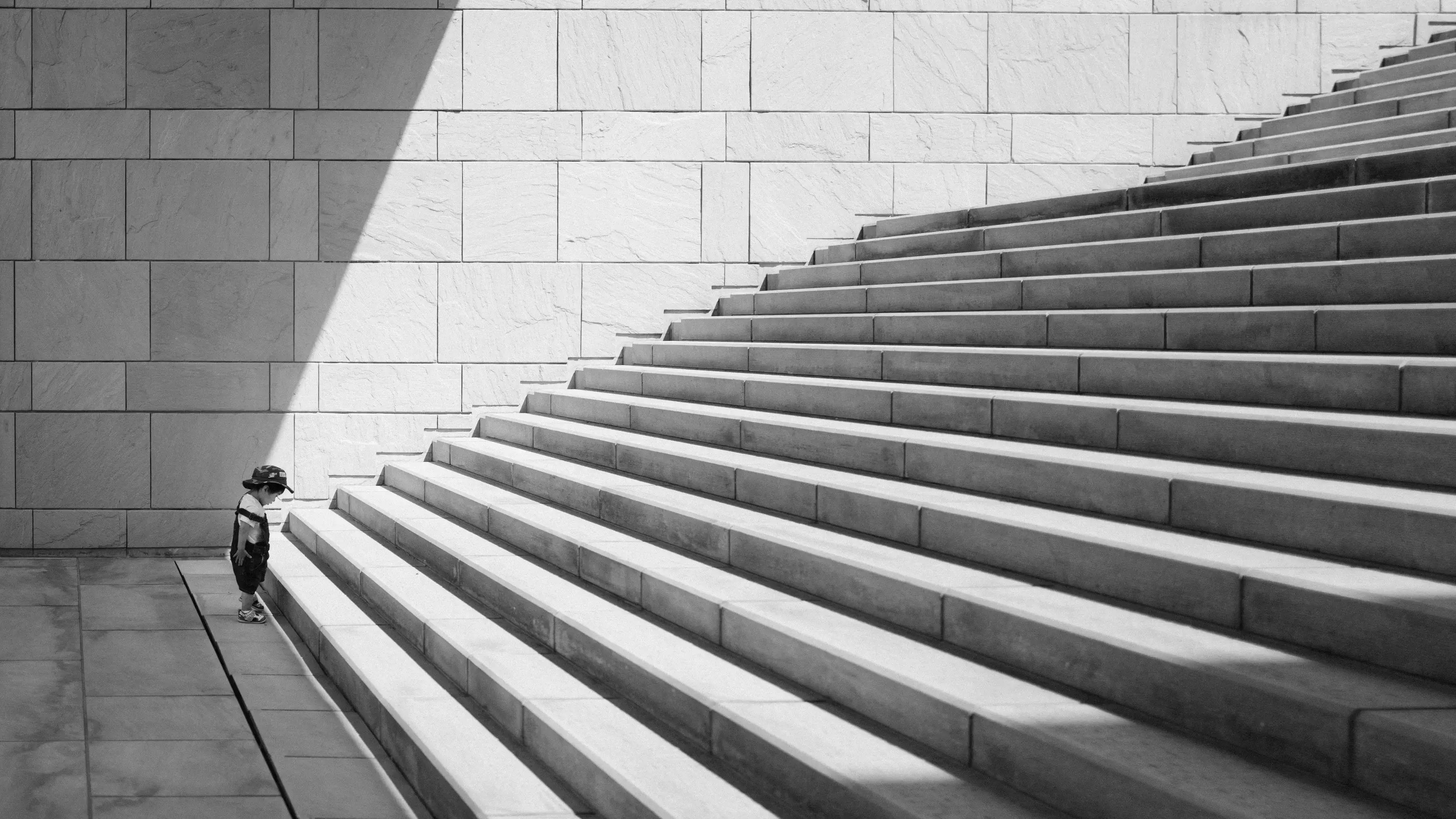 A black and white perspective shot of wide stone outdoor stairs