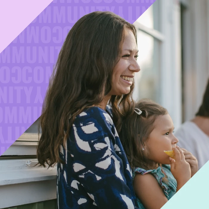 Woman holding baby smiling