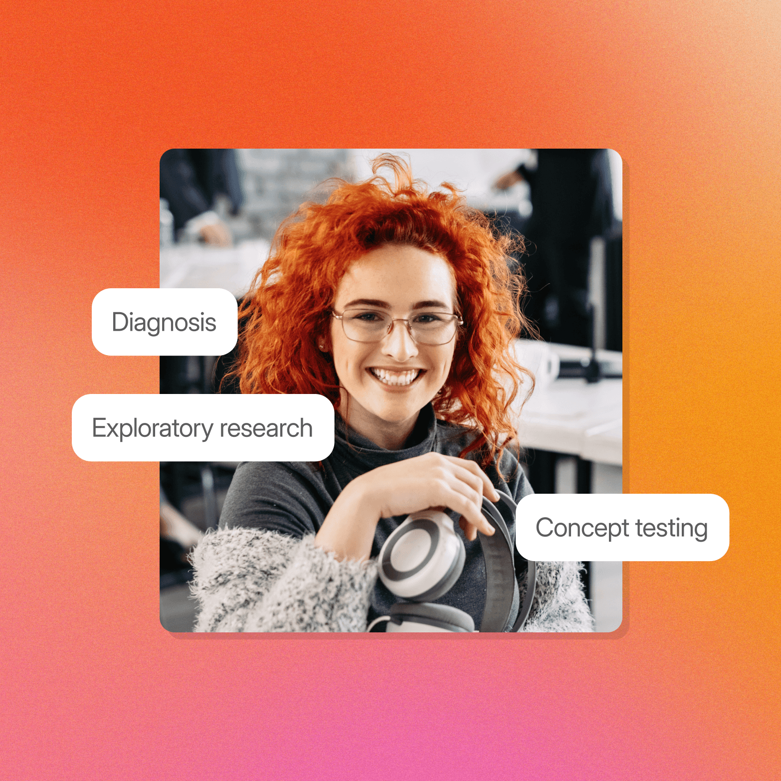 A smiling woman with curly red hair and glasses holds a pair of headphones in an office setting, with three white pill-shaped labels overlaid on the image: "Diagnosis" (upper left), "Exploratory research" (left), and "Concept testing" (right). The image sits on a warm orange-to-pink gradient background.