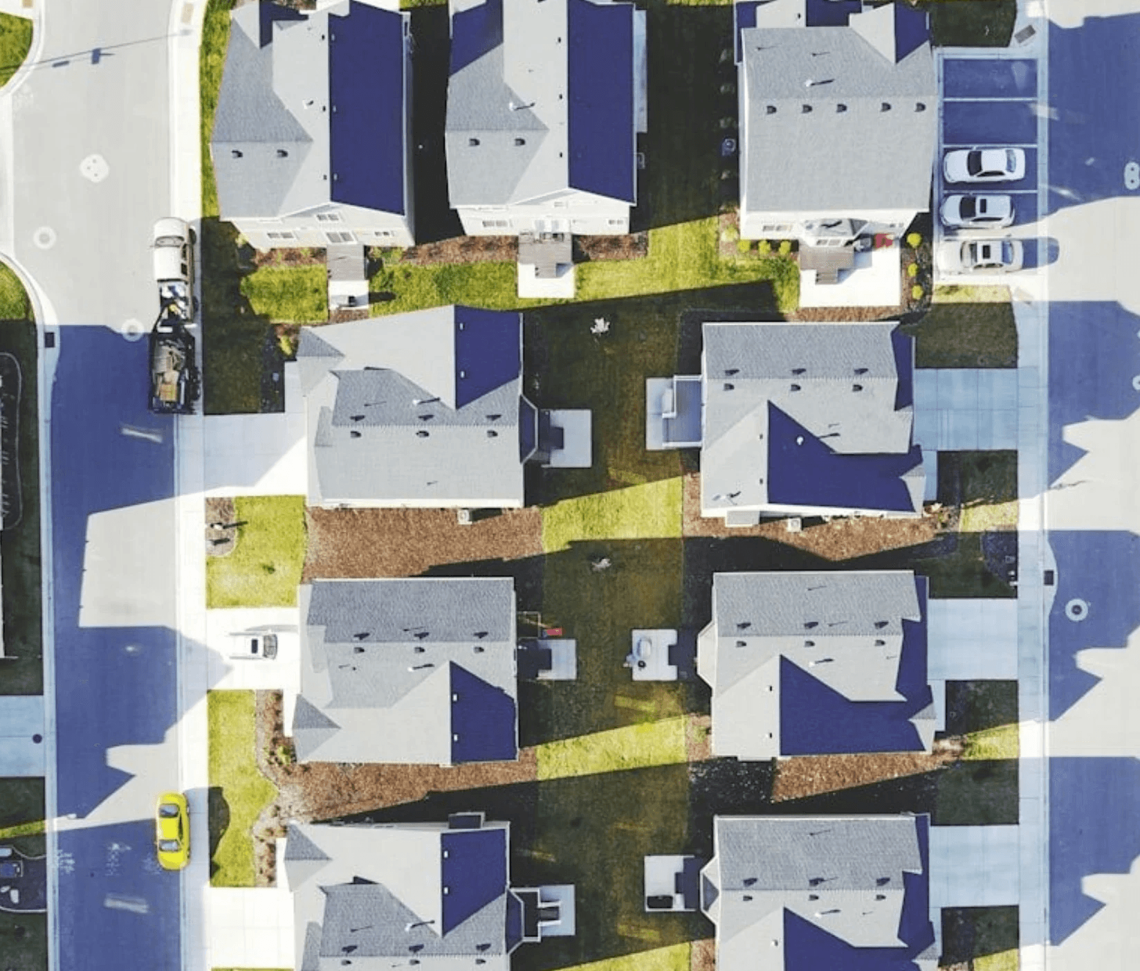 Aerial view of suburban houses with dark blue roofs