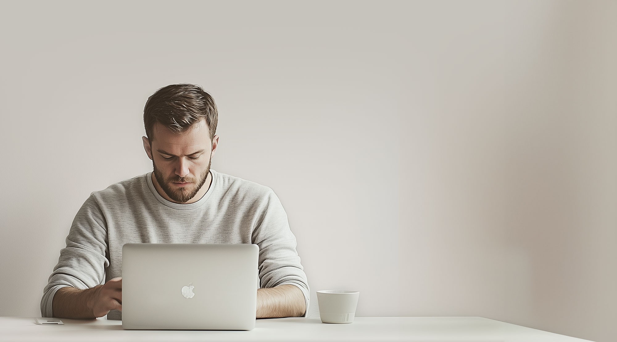 Foucs looking Man sits behind his laptop