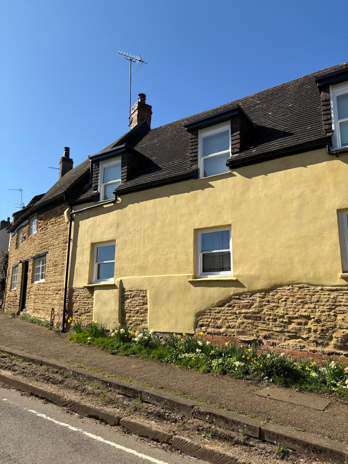 Traditional lime render on a historic Northampton property, designed with breathable materials and partial stone exposure for heritage authenticity.