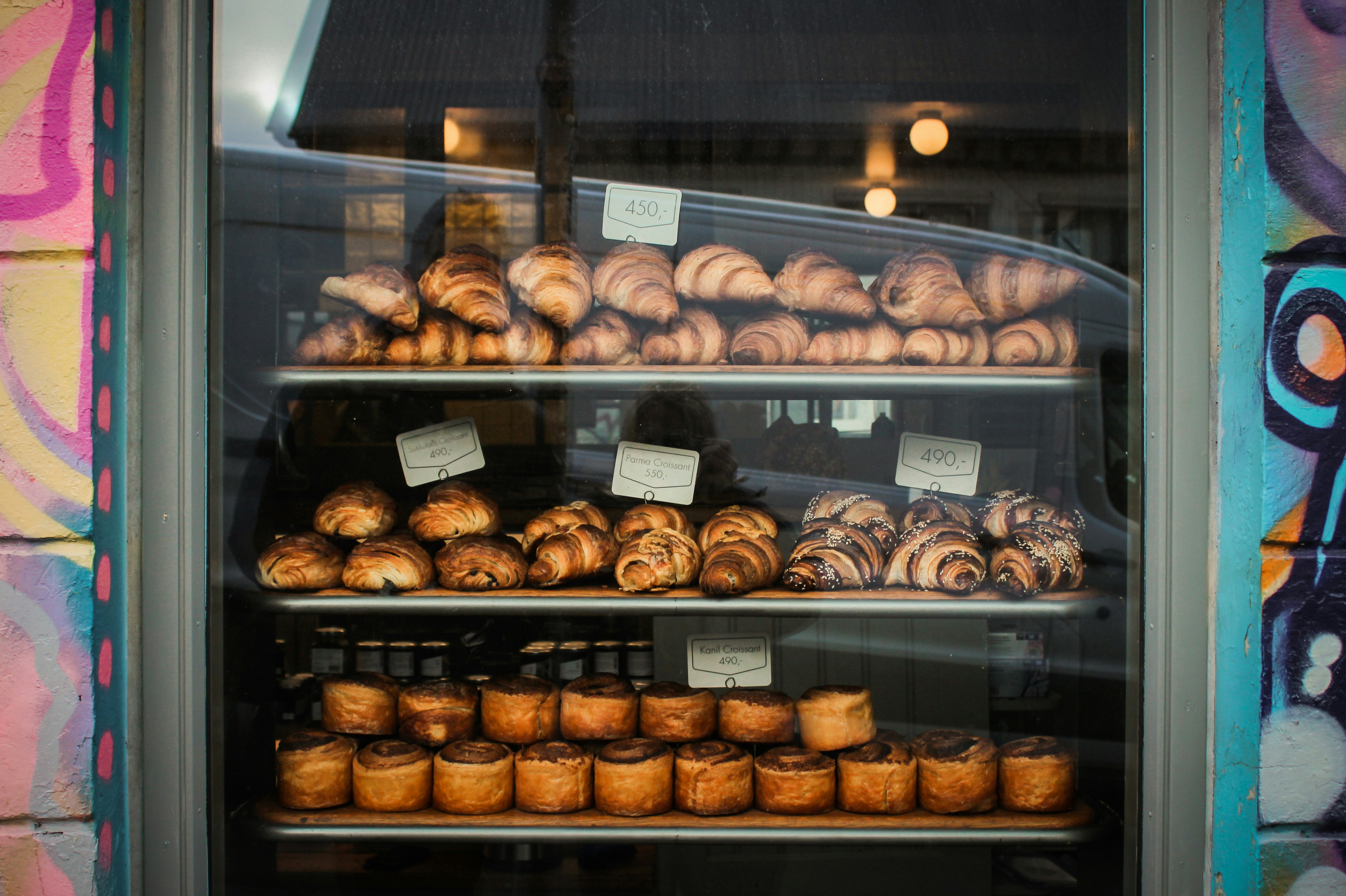 Pastry display at Brauð & Co seen through the window from outside.