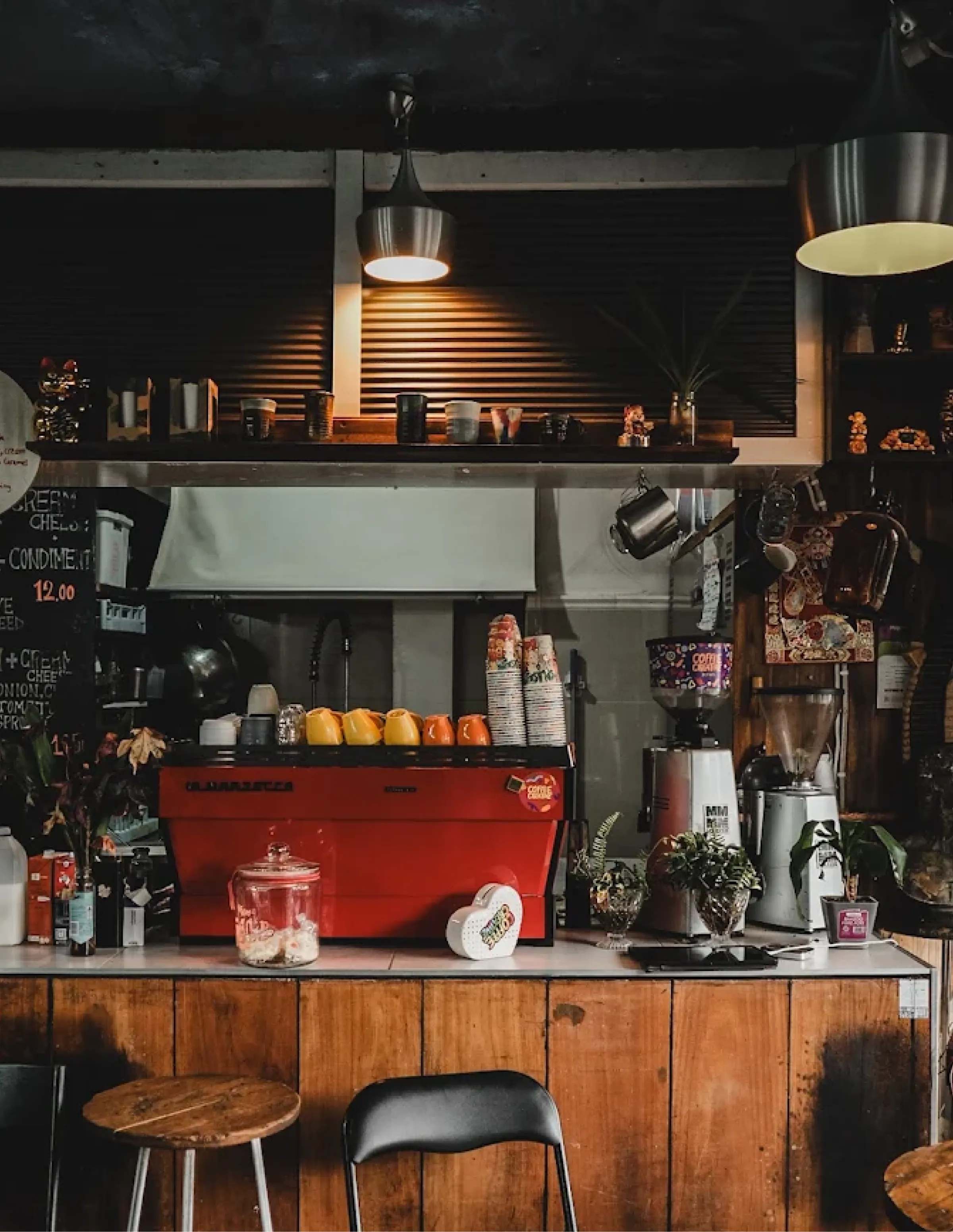 Interior of Coffee Creative coffee shop with red espresso machine and warm lighting