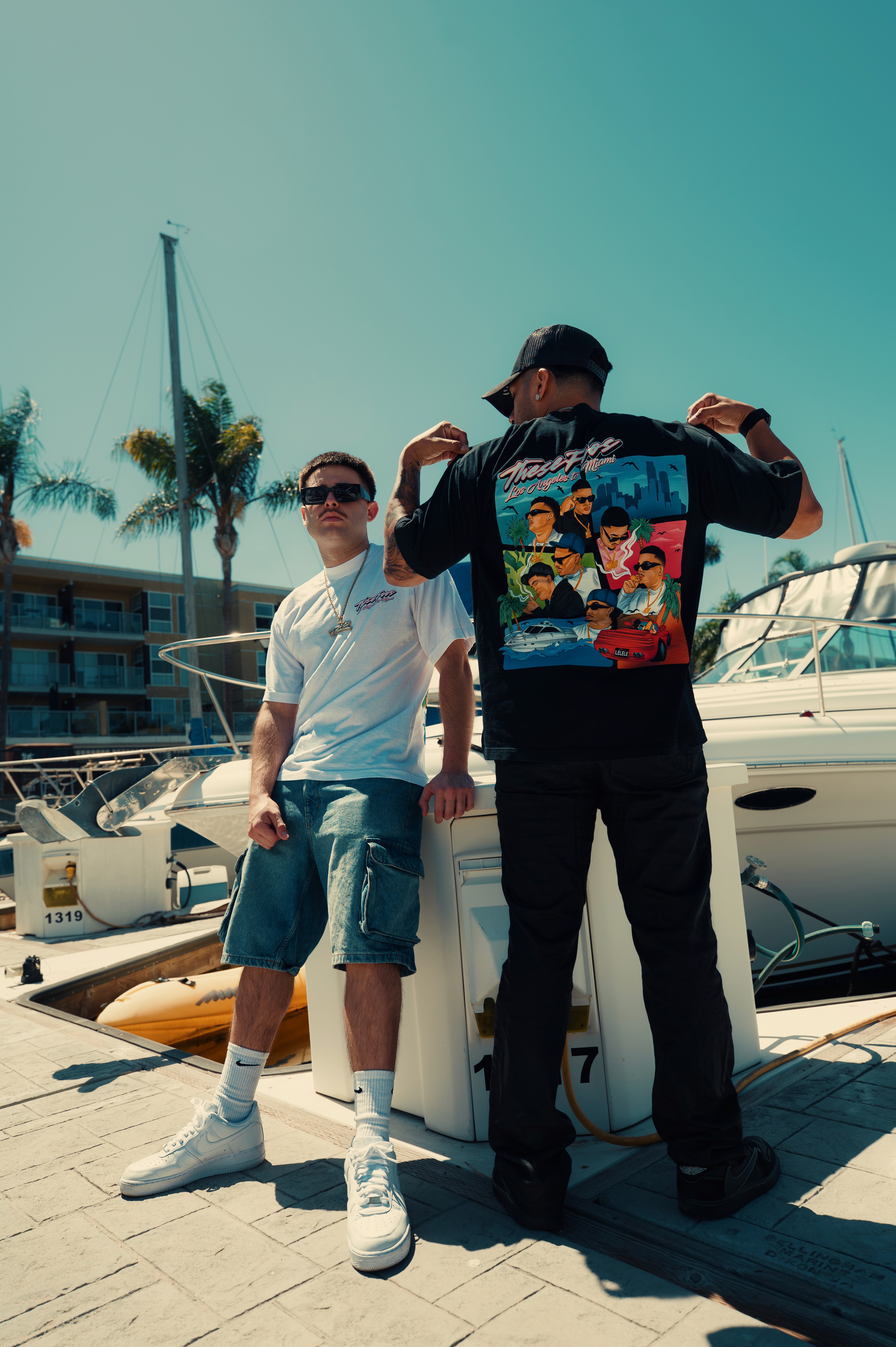 a group of people sitting around a laptop computer