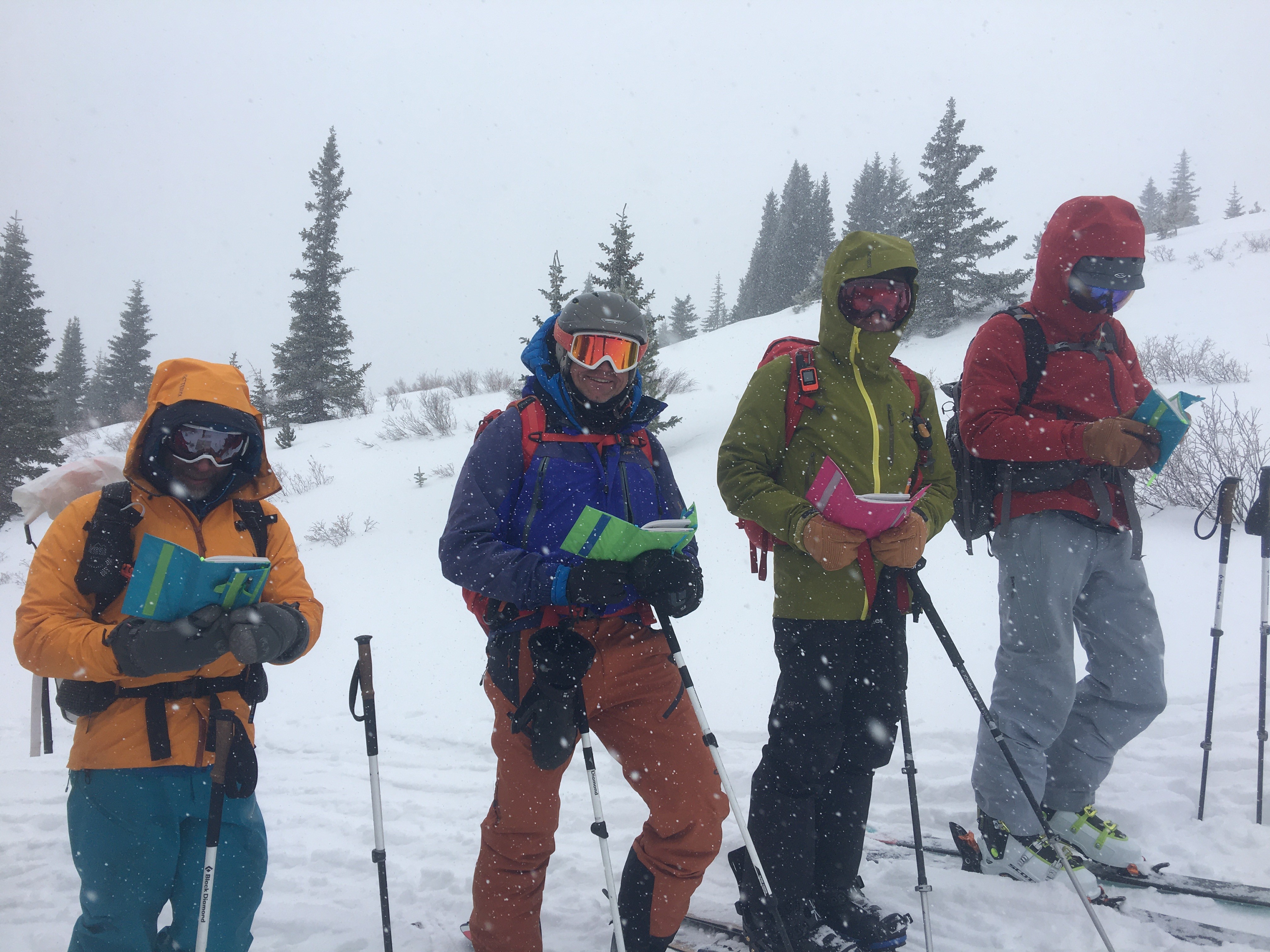 AIARE Students look at their notes on snow conditions