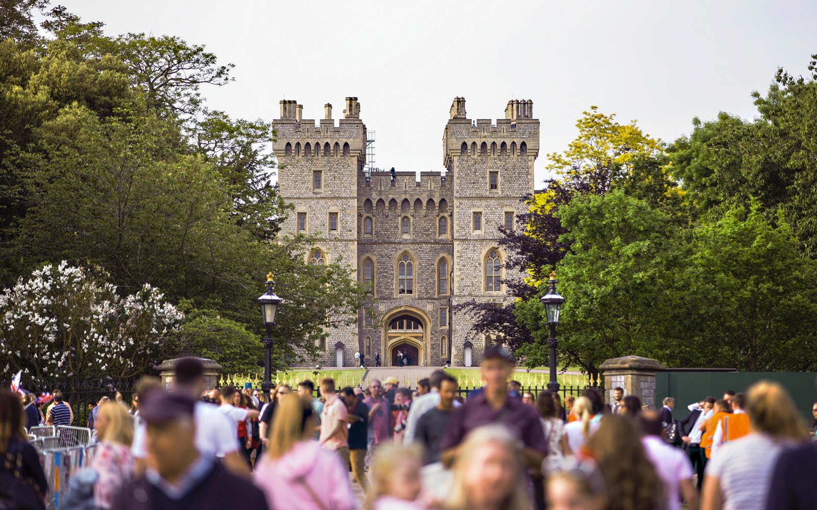 Windsor Castle exterior with tourists exploring the historic site in Windsor, England.