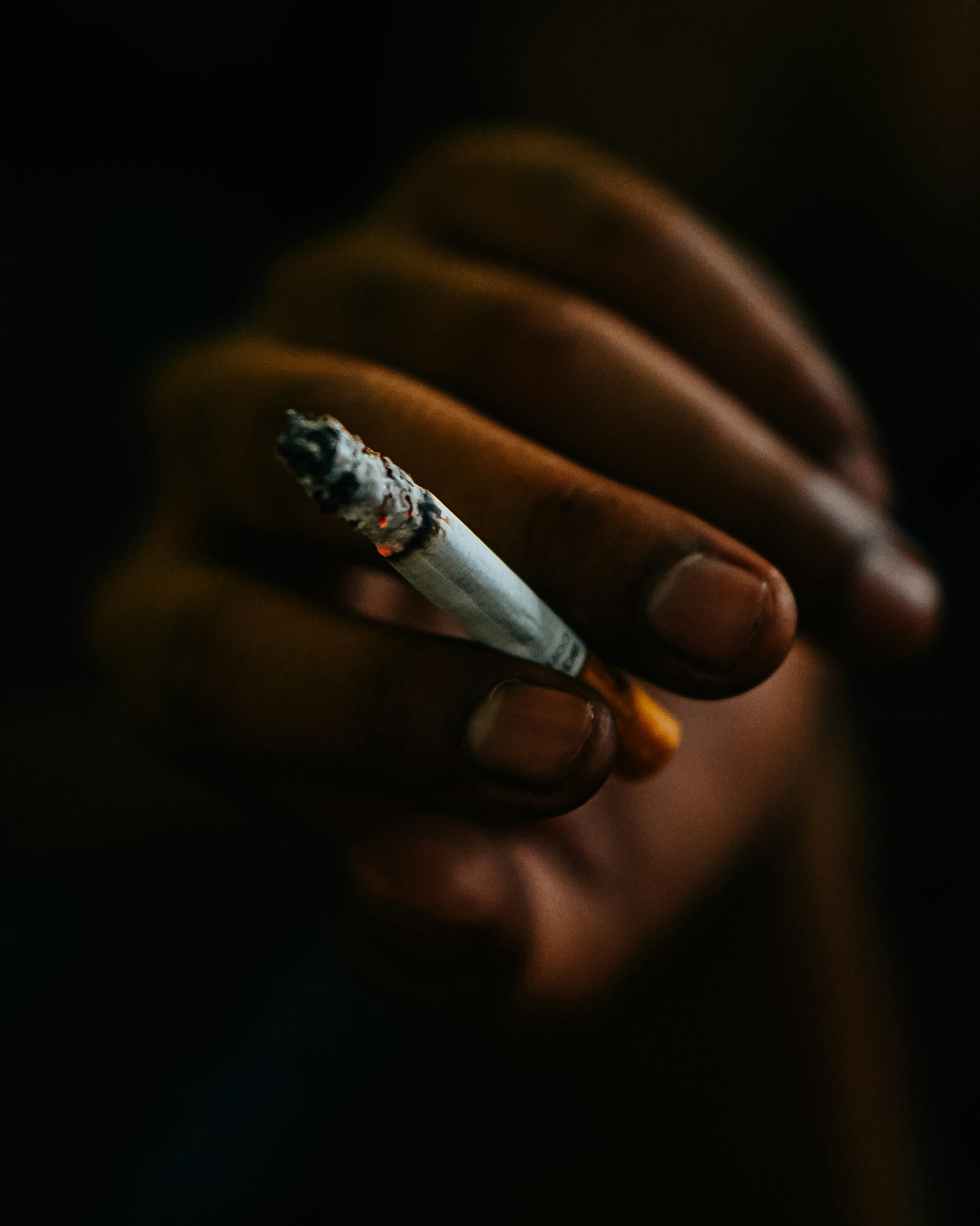 person holding white cigarette stick