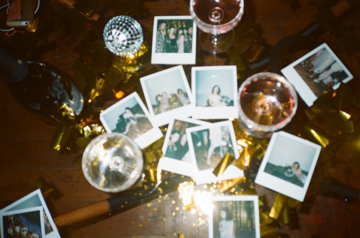 Polaroids and disco balls scattered around as NYE party decor