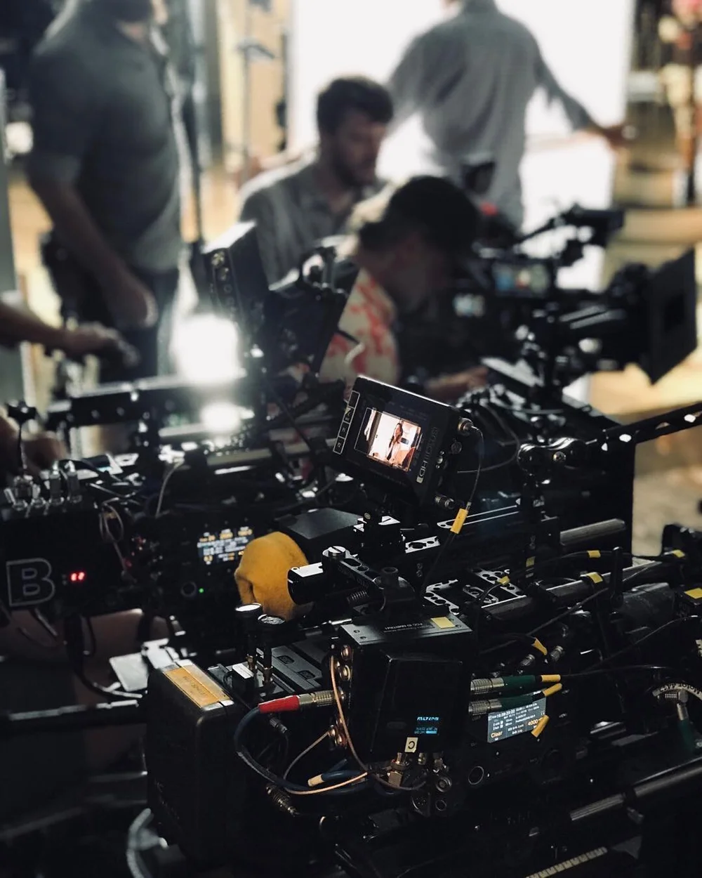Filming crew with camera on dolly in room