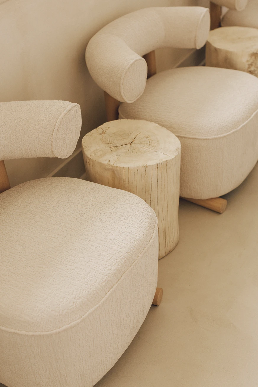 Neutral lounge seating in the waiting area of Manipura wellness clinic interior design