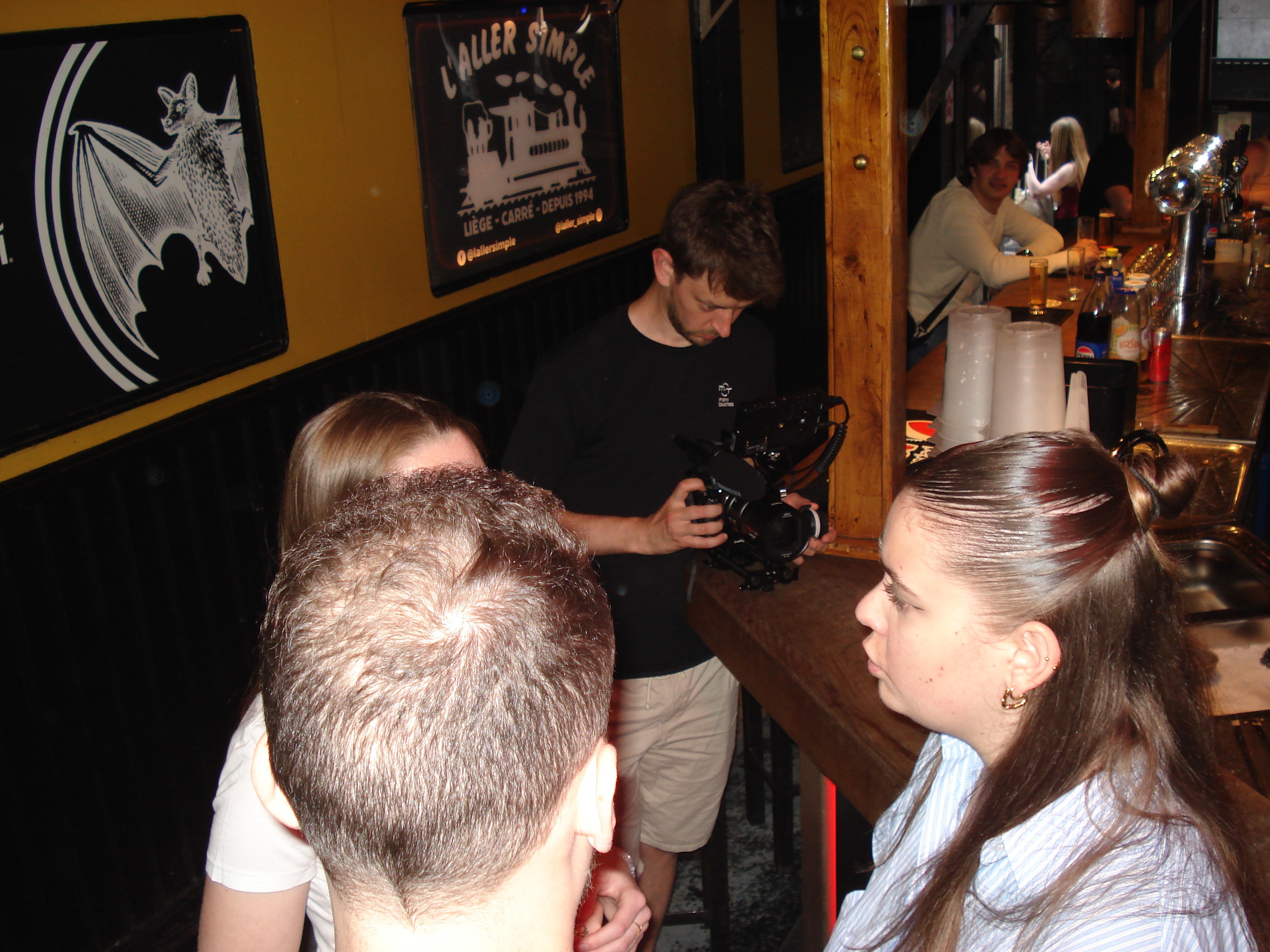 Videographer filming a scene in a bar