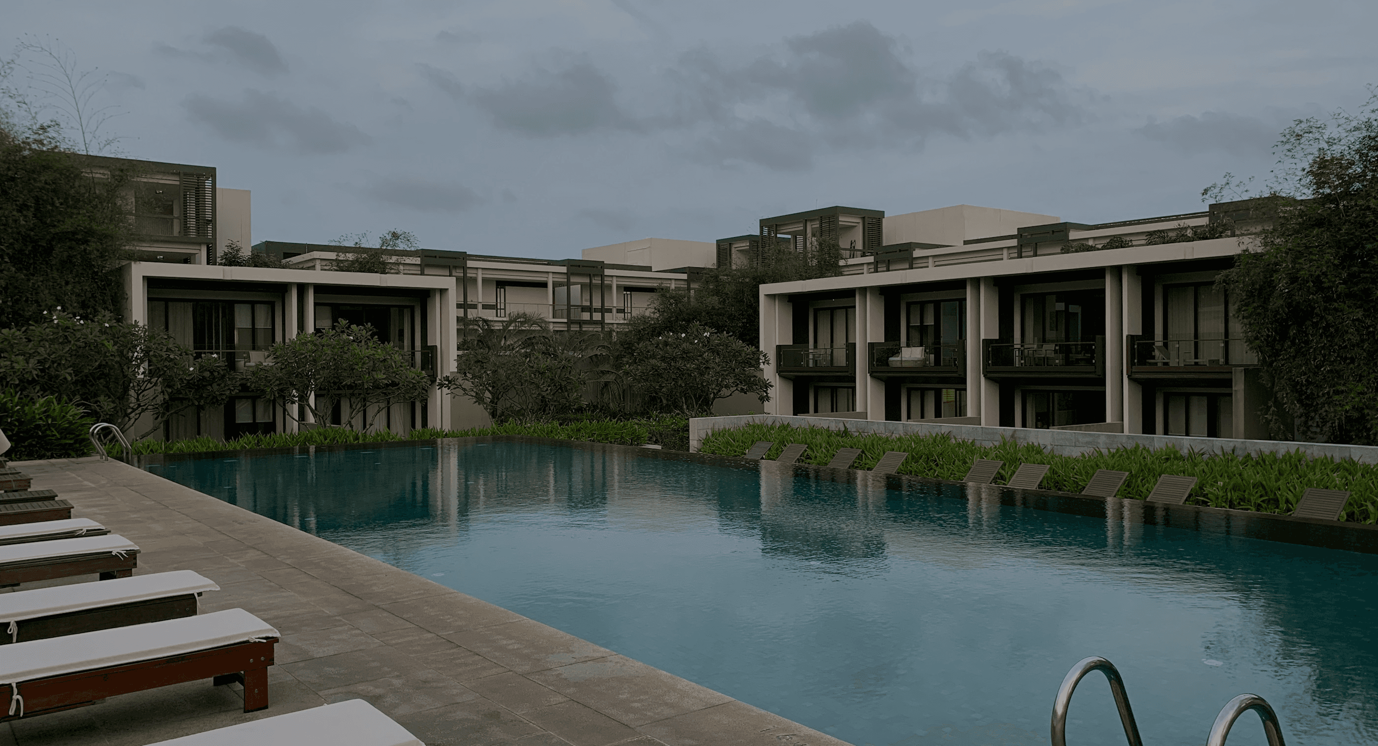 Naraya Lagoon resort building beside the infinity pool and sun loungers