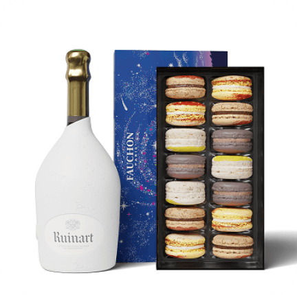 Ruinart white champagne bottle and Fauchon macaron box against white background