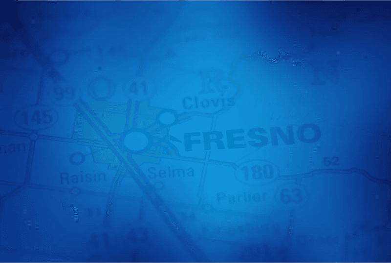 OnCall medical transport van parked at a Fresno medical clinic.