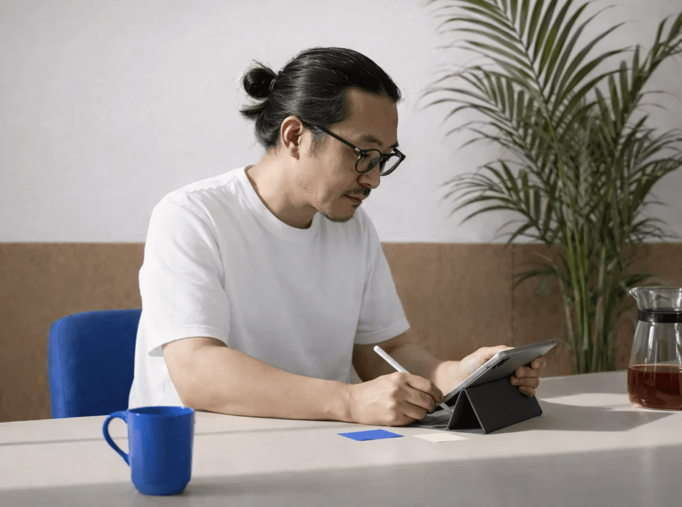 woman in brown coat using macbook air