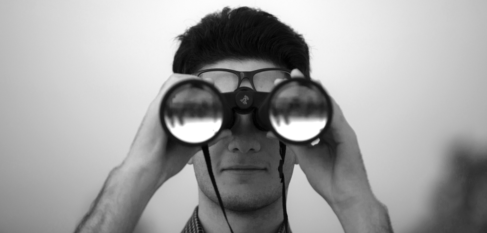 grayscale photo of rock formation on sea