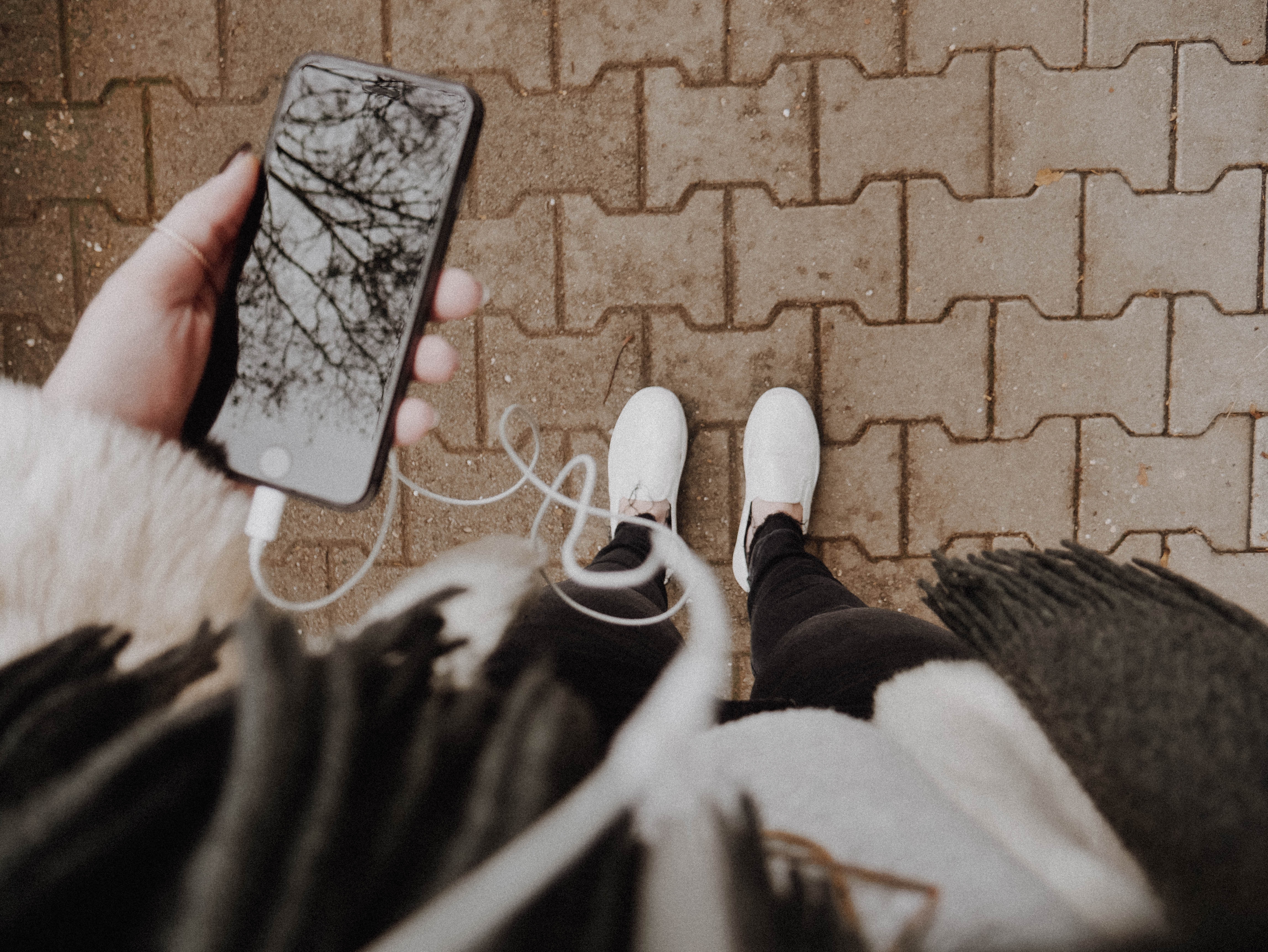 Woman looking at her phone and changin music - ai artist singing other songs