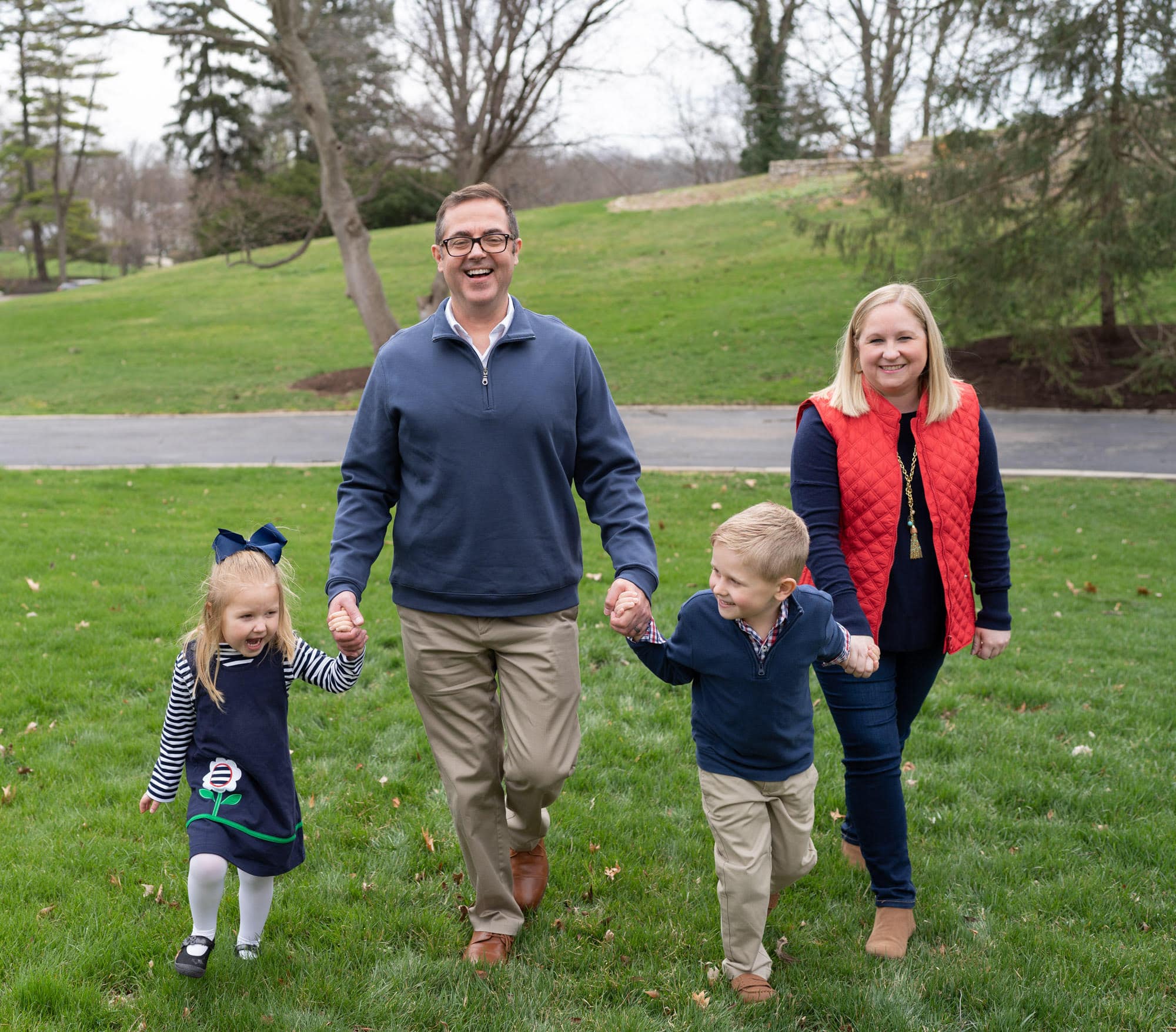 Steve and Ashlee Abshire walking hand in hand with their young daughter and son