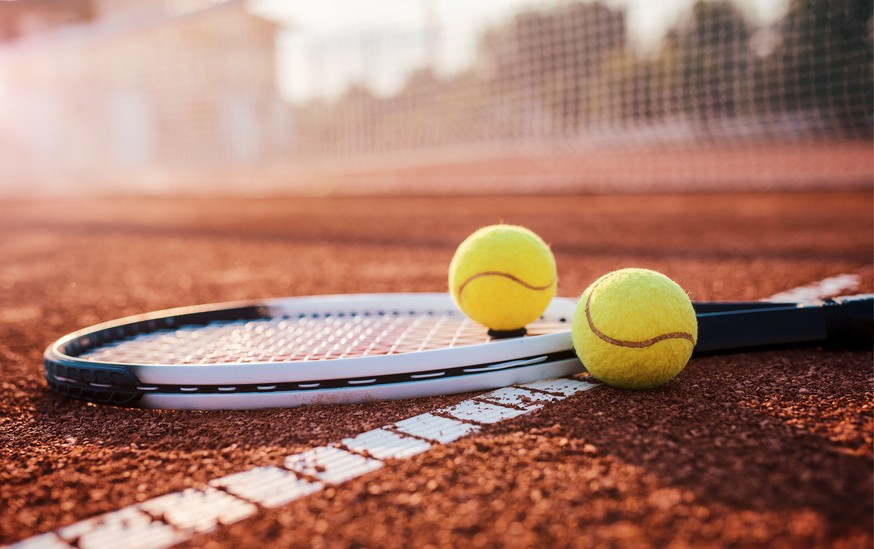 a group of people playing tennis on a tennis court