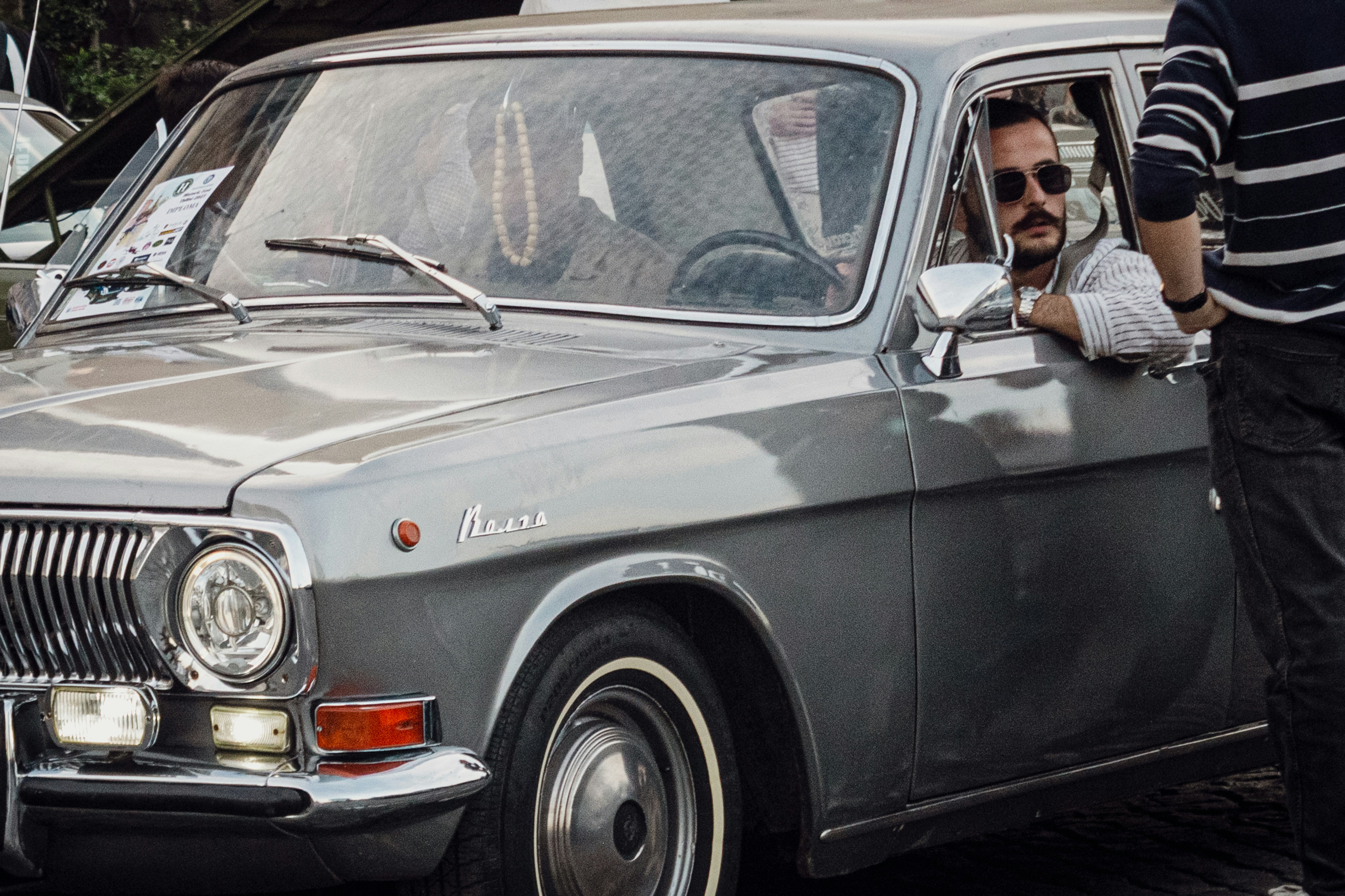 a man sitting in the driver's seat of a car