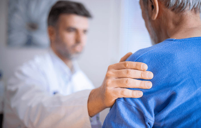 Doctor placing reassuring hand on patient’s shoulder.