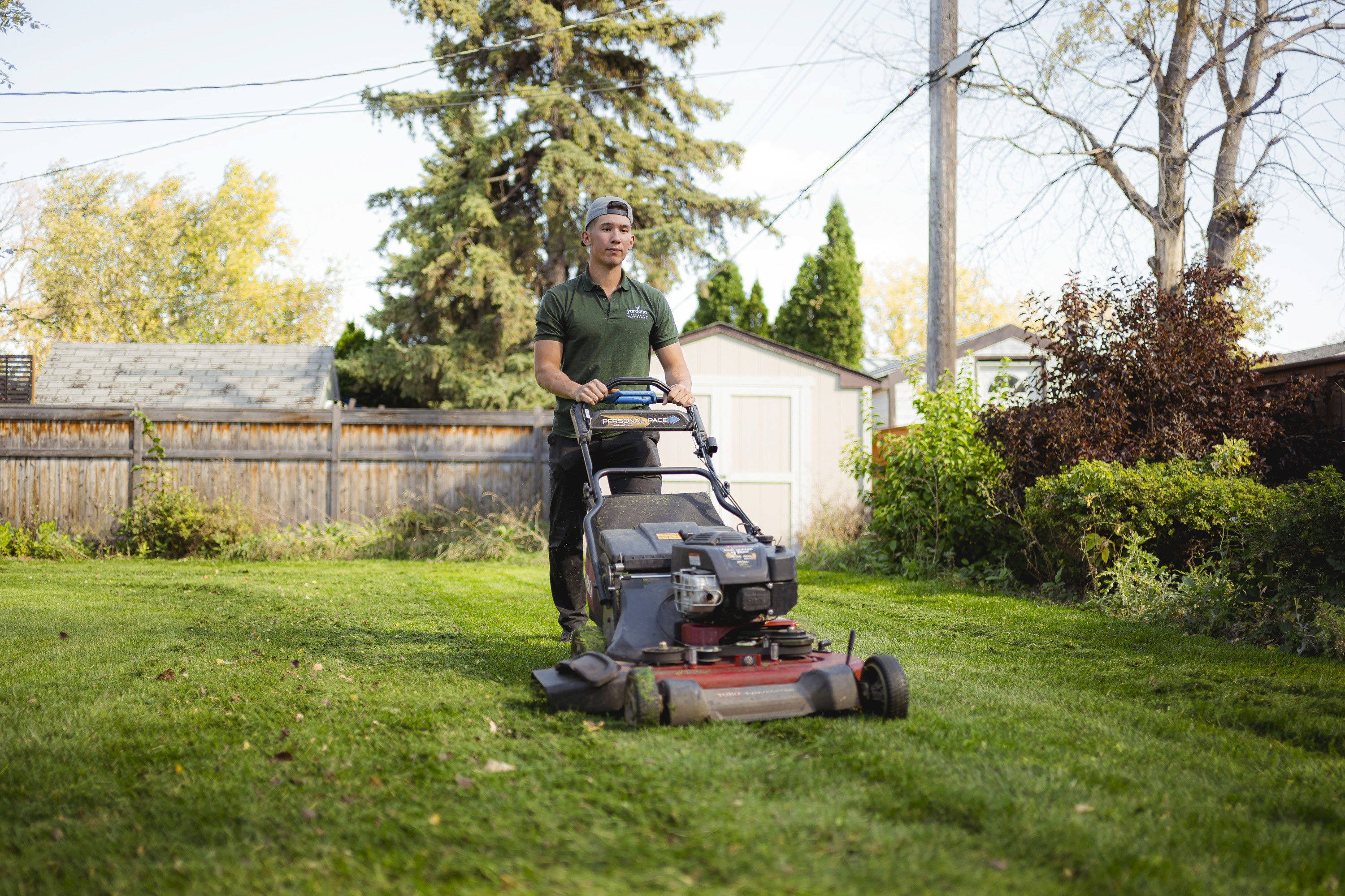 Lawn Mowing in Winnipeg. The employee is mulching the grass with a 30 inch mower