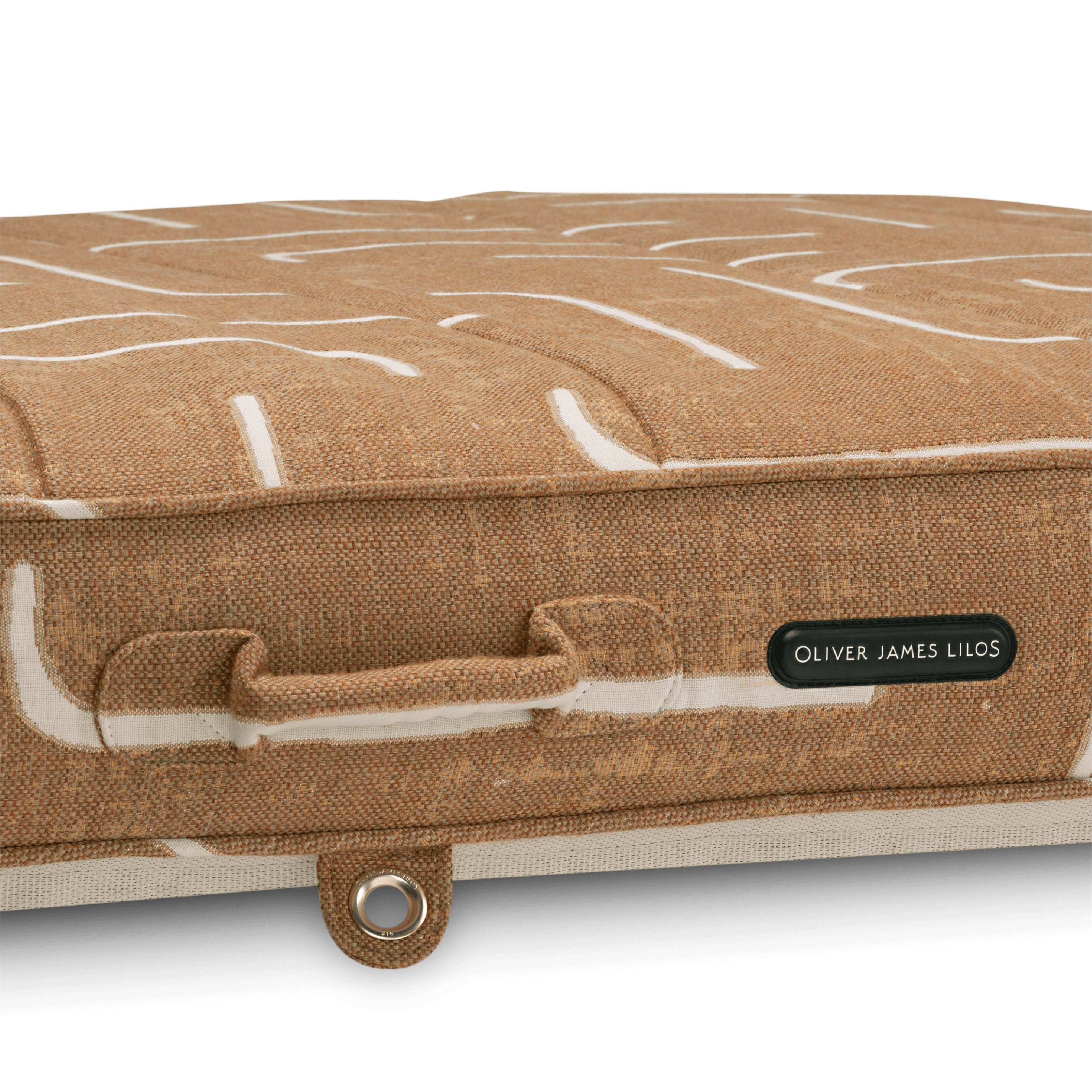 Close-up of pool float showing gold-and-brown weave handle, gold stainless eyelet, and thick textured fabric