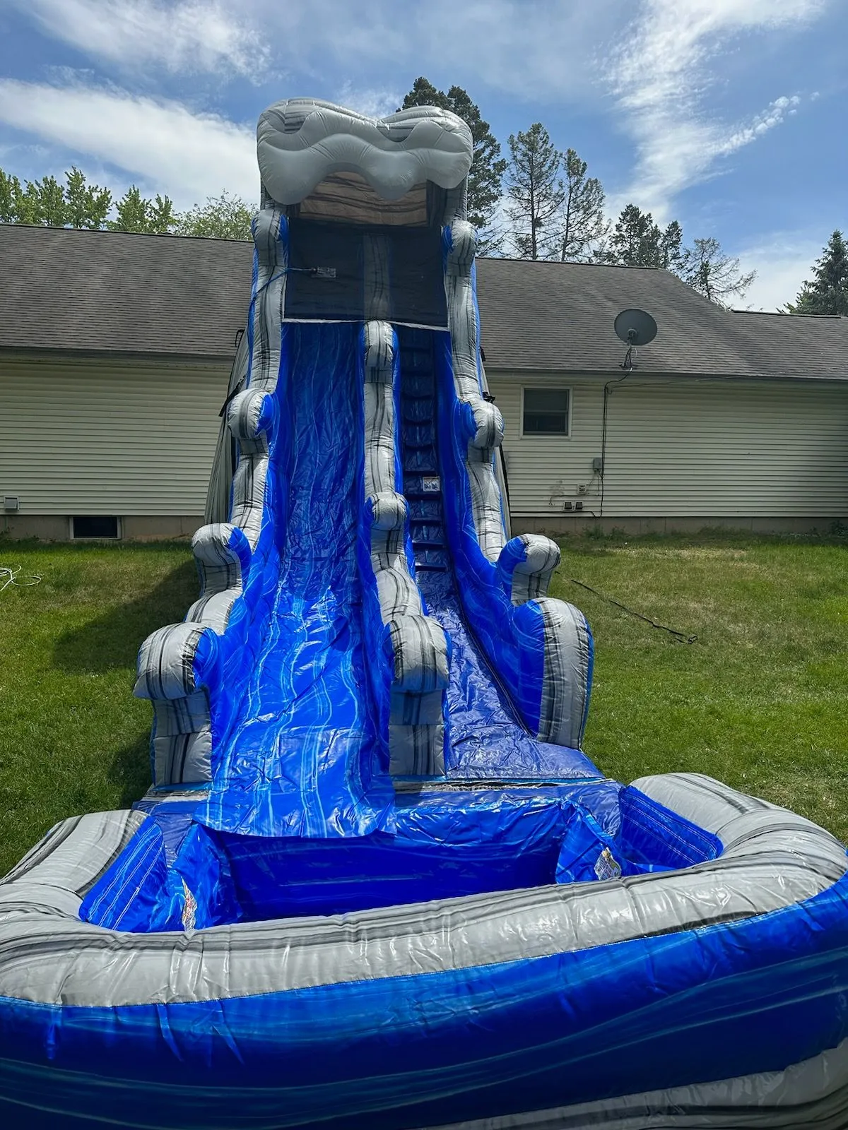 front view of slide with a water theme and pool attached